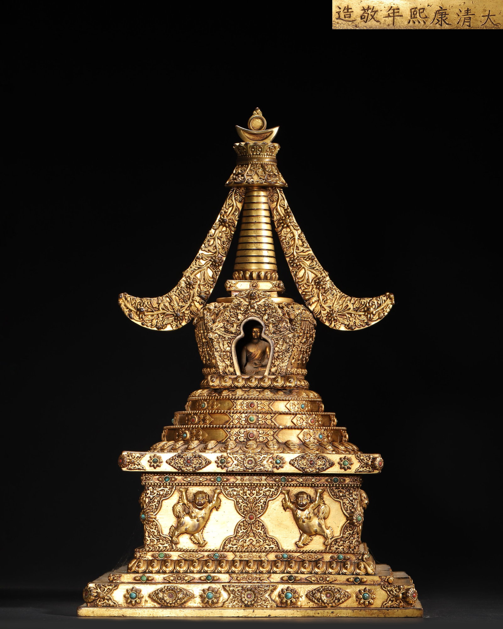IMPERIAL COMMISSIONED GILT-BRONZE RELIC STUPA WITH GEM INLAY, QING DYNASTY, KANGXI PERIOD: H:40CM(15.75 inches)An imperial gilt-bronze relic stupa from the Kangxi period, Qing Dynasty. Richly gilded and inlaid with precious stones, it features an elaborate structure with a well-proportioned