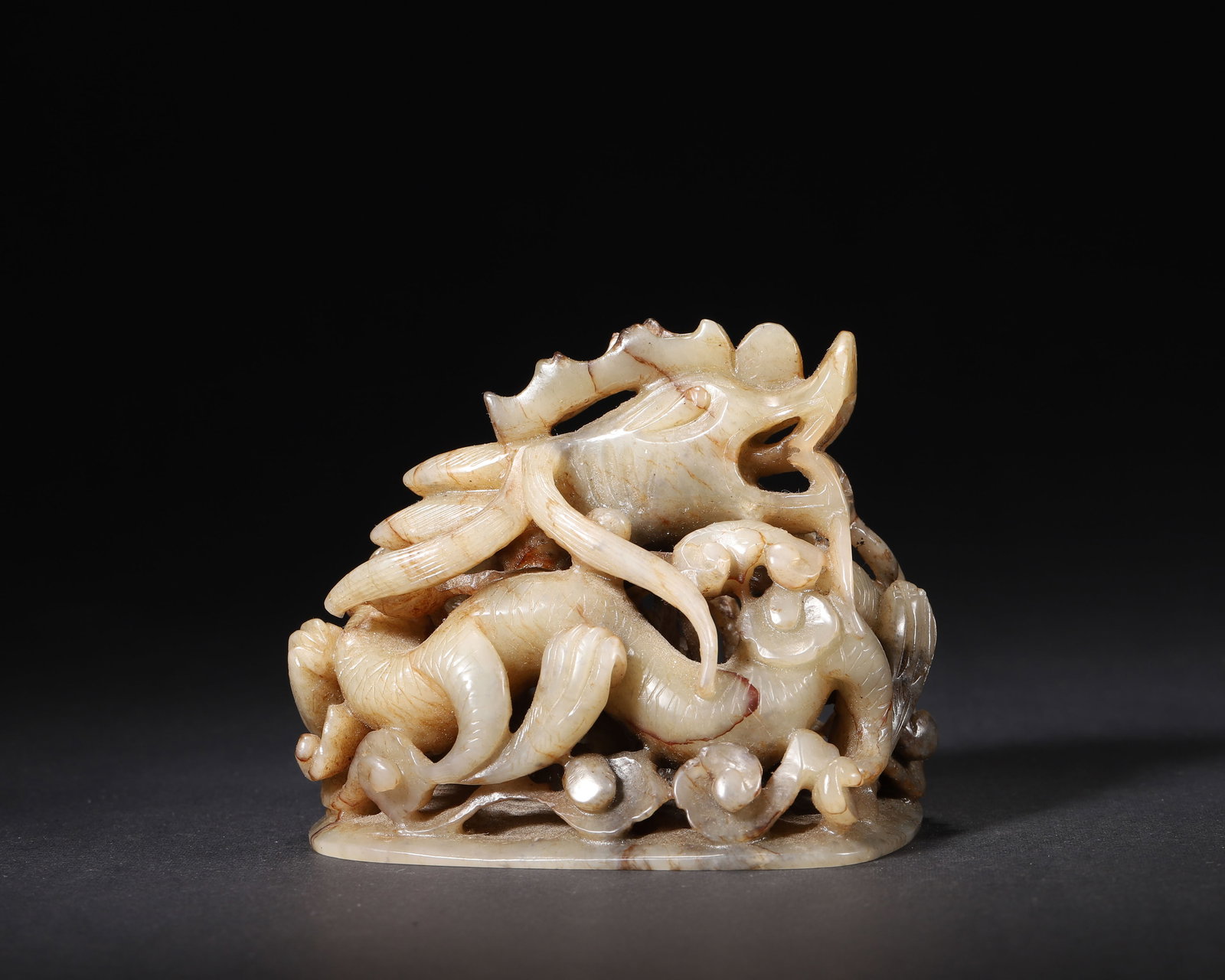 HETIAN JADE RETICULATED 'DRAGON' CENSER FINIAL, YUAN DYNASTY: 3.35" x 2.56" x 3.15" inches (8.5 cm x 6.5 cm x 8.0 cm) | Weight: 0.68 lbs (308.0 g)A court jade object from the Yuan Dynasty, carved from Hetian jade with multi-layered reticulation. The dynamic drag