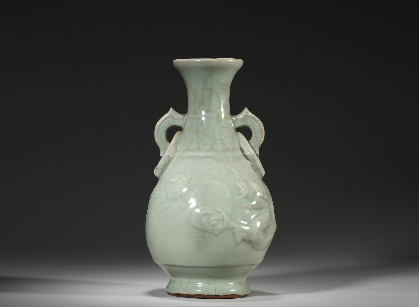 YUAN DYNASTY, LONGQUAN CELADON VASE WITH APPLIED DRAGON DESIGN AND RING HANDLES: 4.72" x 9.06" inches (12.0 cm x 23.0 cm)This robust vase features a luscious jade-like celadon glaze with natural crackles. The dynamic applied dragon motifs and ring handles exemplify the powerful ae