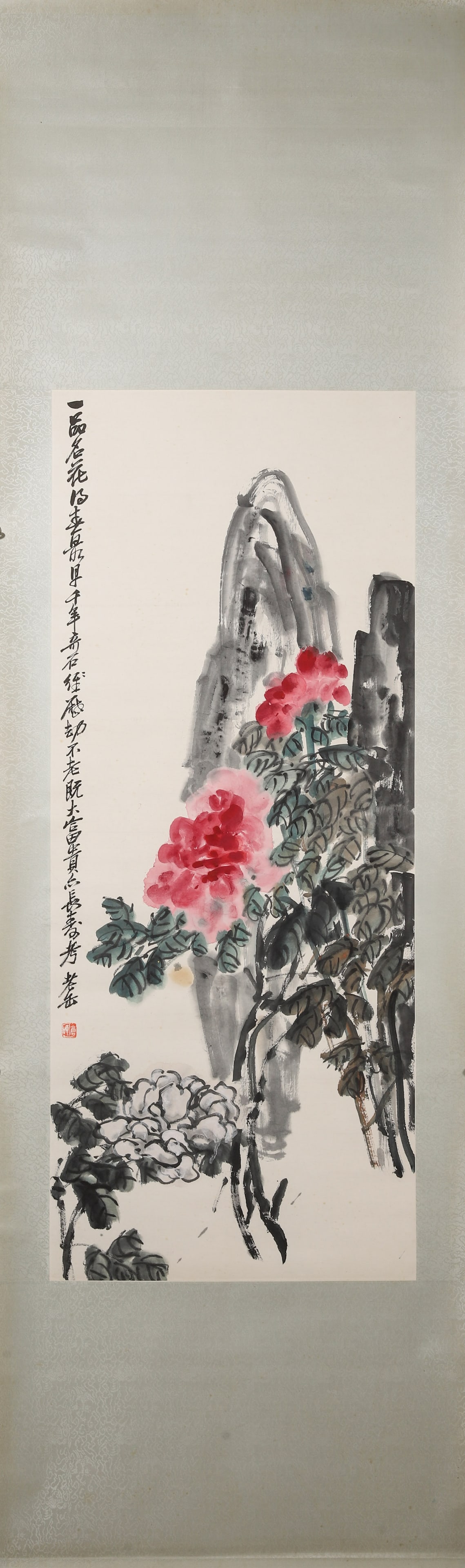 MODERN, C. 1920: WU CHANGSHUO, "NOBLE FLOWER" HANGING SCROLL: Paper Texture, 49.21 inches x 8.27 inches (125.0 cm x 21.0 cm)A late-period masterpiece by Wu Changshuo, depicting peonies and rocks with bold brushwork and vivid colors, blending epigraphic charm and