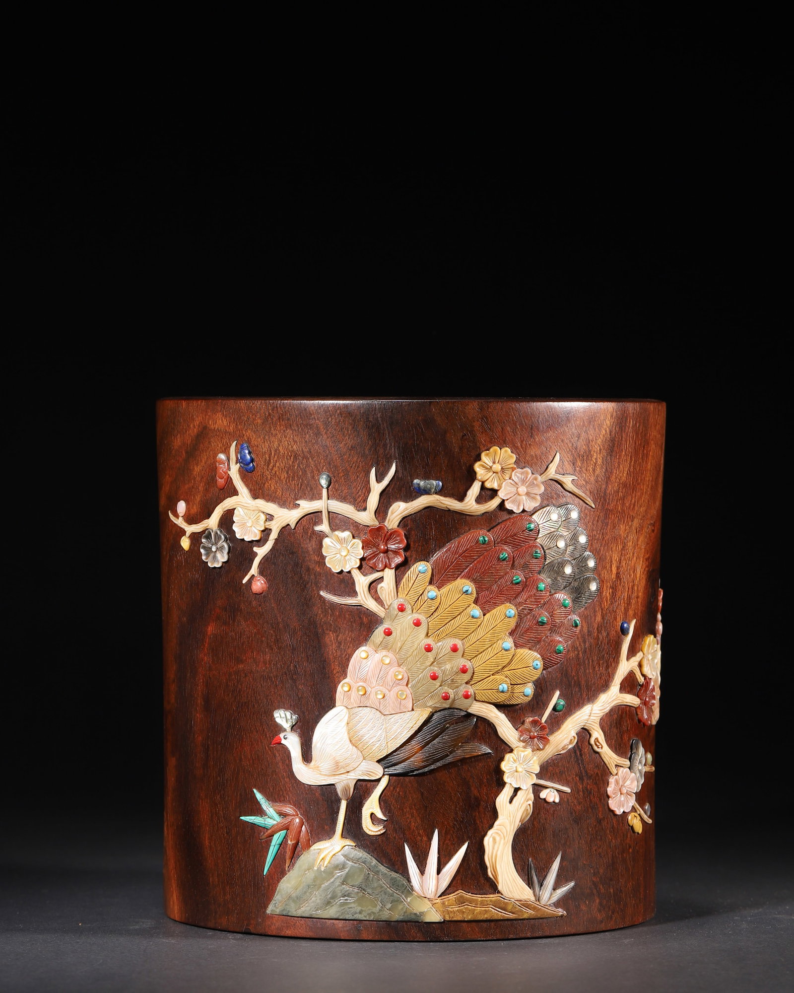 QING DYNASTY, QIANLONG PERIOD, HUANGHUALI WOOD BRUSH POT WITH HUNDRED TREASURES INLAY OF PEACOCK AND: D 7.50" x H 7.50" (D 19.0cm x H 19.0cm) | 5.34lbA fine scholar's object from the Qianlong period of the Qing Dynasty. The huanghuali wood brush pot features elaborate "hundred treasures" inlay of a pe