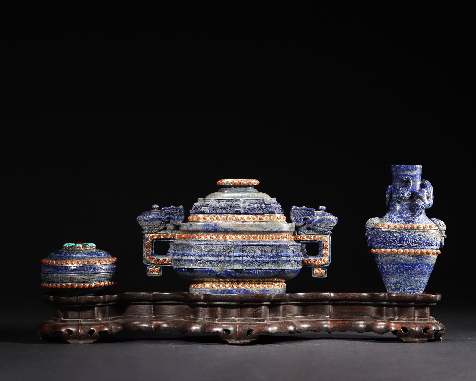A SET OF THREE LAPIS LAZULI, AGATE-INLAID AND GILT BRONZE VESSELS, QIANLONG PERIOD, QING DYNASTY: 7.88" x 3.50" x 4.75" (2.0cm x 9.0cm x 12.0cm) | 4.45lbThis set of three lapis lazuli vessels, inlaid with agate and turquoise and accented with gilt bronze, features archaistic forms and intricate ca