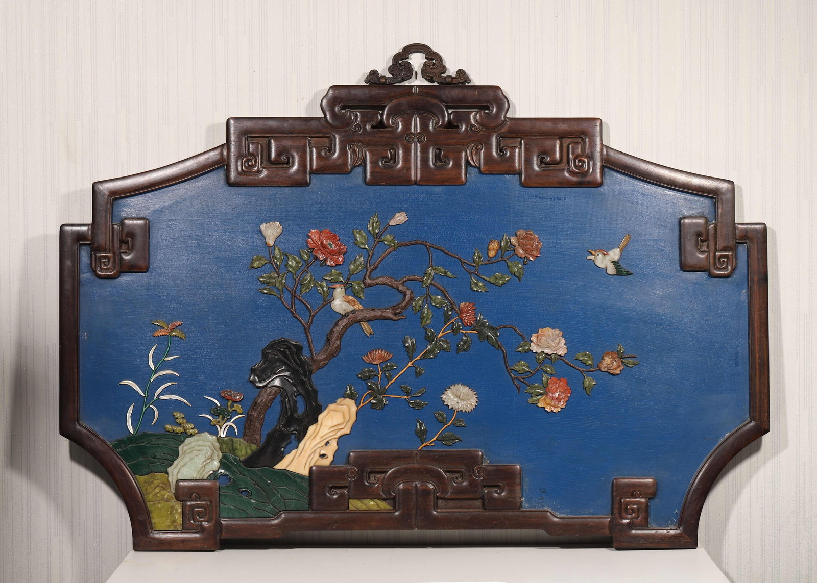 A ZITAN WOOD AND BLUE LACQUER WALL SCREEN INLAID WITH GEMSTONES, FLOWER AND BIRD MOTIF, QIANLONG: 43.75" x 28.75" (111.0cm x 73.0cm)This wall screen features a zitan wood frame, blue lacquer background, and gemstone-inlaid flower and bird motifs. Exquisitely crafted, it was an imperial display pie
