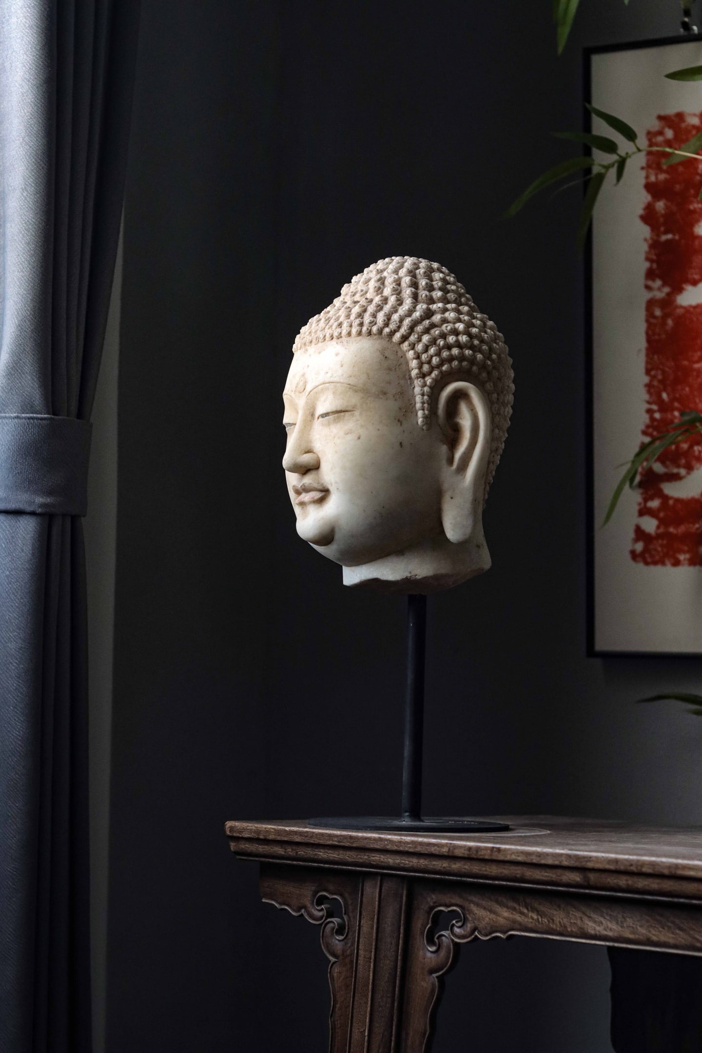WHITE MARBLE HEAD OF BUDDHA, TANG DYNASTY: Height without base: 11.02" inches (28cm), Diameter: 8.27" inches (21cm)Carved with a plump, serene face, downcast eyes, and a subtle smile. The hair in tight, spiraled curls, with a prominent urna on