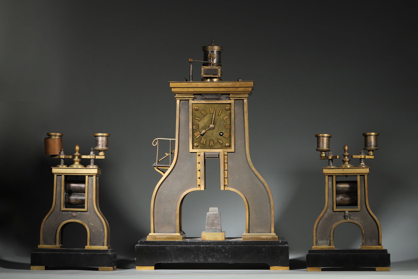 French Brass Roman Numeral Dial Air Hammer Clock: Clock: 30x14x47cm; Candlesticks: 15x9x26cm, Weight 12795g (Clock: 11.81"x5.51"x18.50"; Candlesticks: 5.91"x3.54"x10.24", Weight 28.21lb)Fitted with brass hands, this timepiece features a 7-day power r