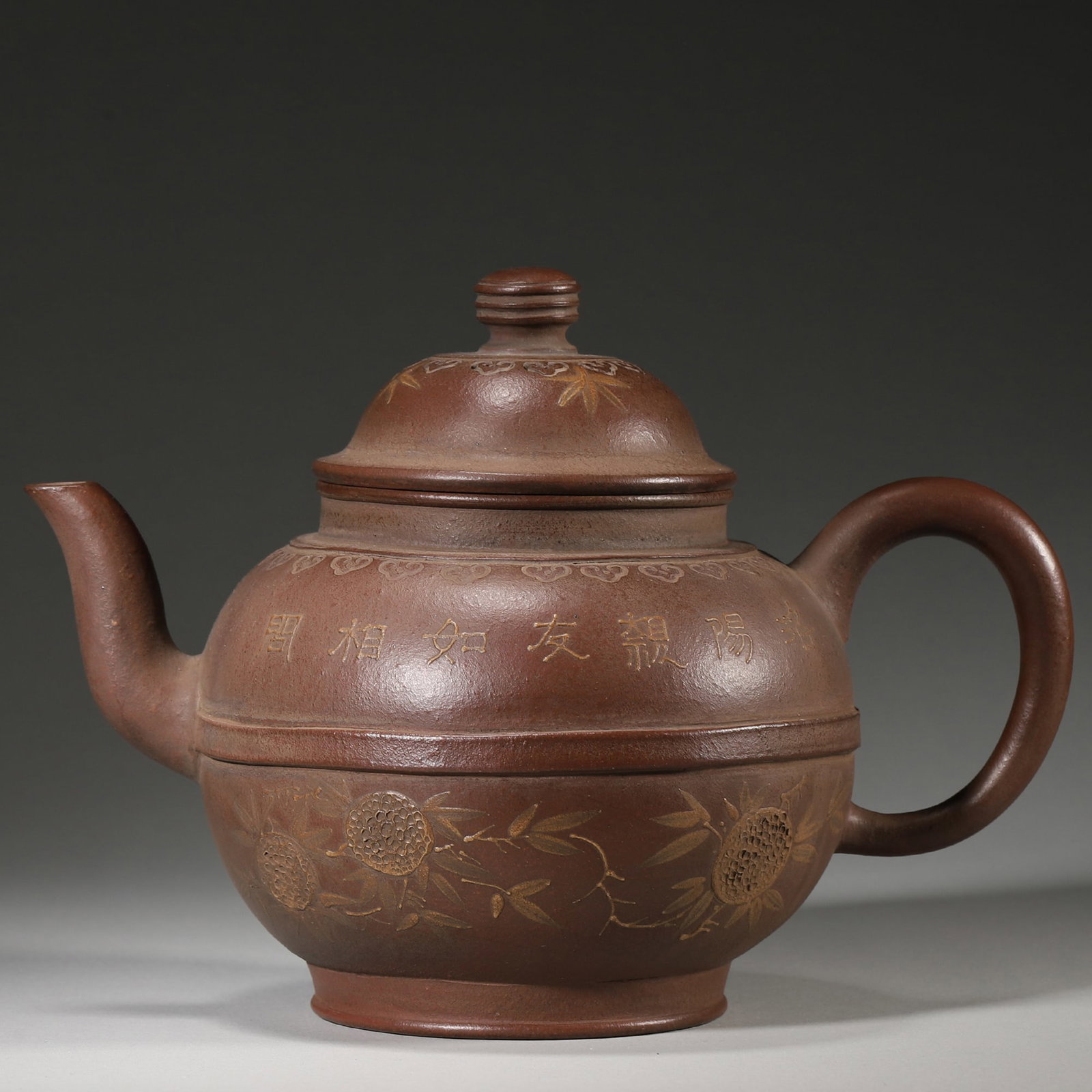 A MID-QING DUAN CLAY YIXING TEAPOT WITH SLIP-DECORATED BIRD-FLOWER AND POEM: 5.51" x 6.3" inches (14.0 cm x 16.0 cm)This teapot is potted from duan clay, decorated with slip-painted bird-flower motif and poetic inscription. Of elegant literati style, well-proportioned form,