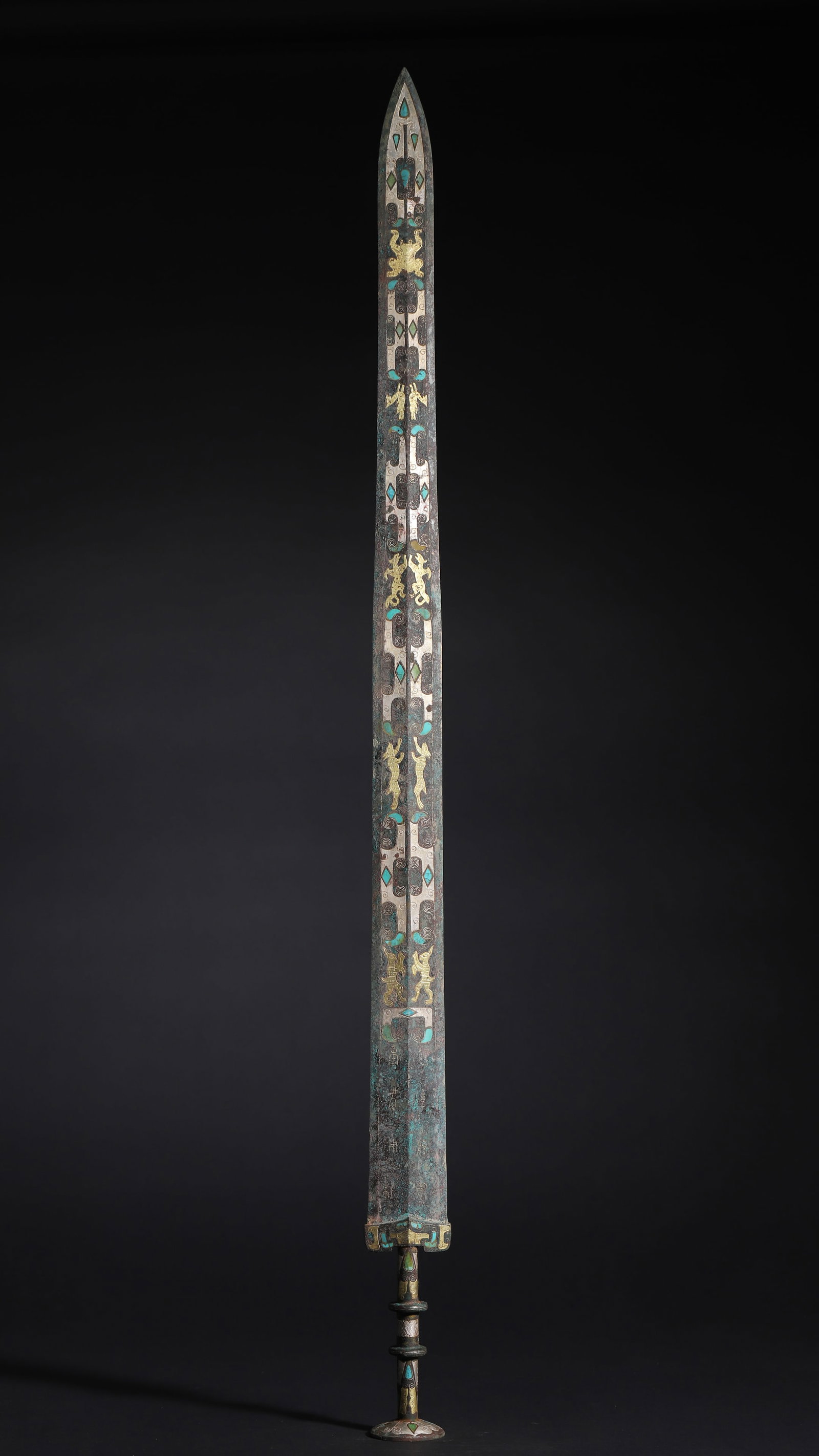 A Warring States Bronze Ornament with Gold, Silver and Turquoise Inlay of Divine Beasts: 35.43" x 1.97" inches (90.0 cm x 5.0 cm) | Weight: 3.53 lbs (1600.0 g)This Warring States bronze ornament features exquisite gold, silver and turquoise inlays depicting divine beasts and chariots. It 