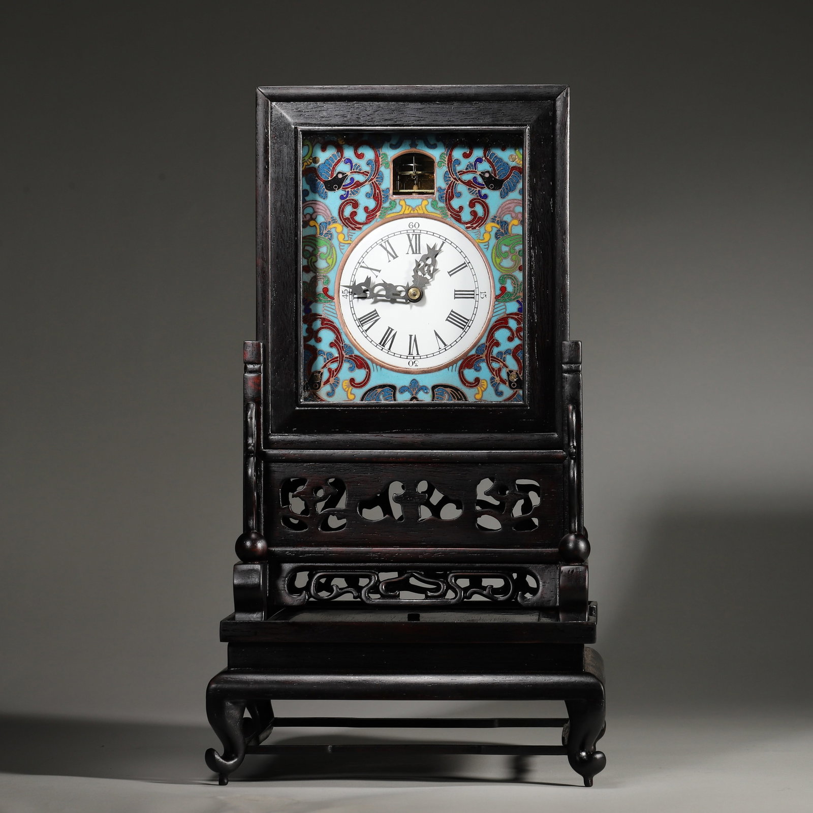 HONGMU MOUNTED CLOISONNÉ ENAMEL MANTEL CLOCK, QING DYNASTY (18TH-19TH CENTURY): 8.07" x 8.07" x 14.37" (20.5cm x 20.5cm x 36.5cm) | 6.18 lbs (2800g)A fine hongmu mounted cloisonné enamel mantel clock, Qing dynasty (18th-19th century), with a floral enamel dial and gilt-brass mov