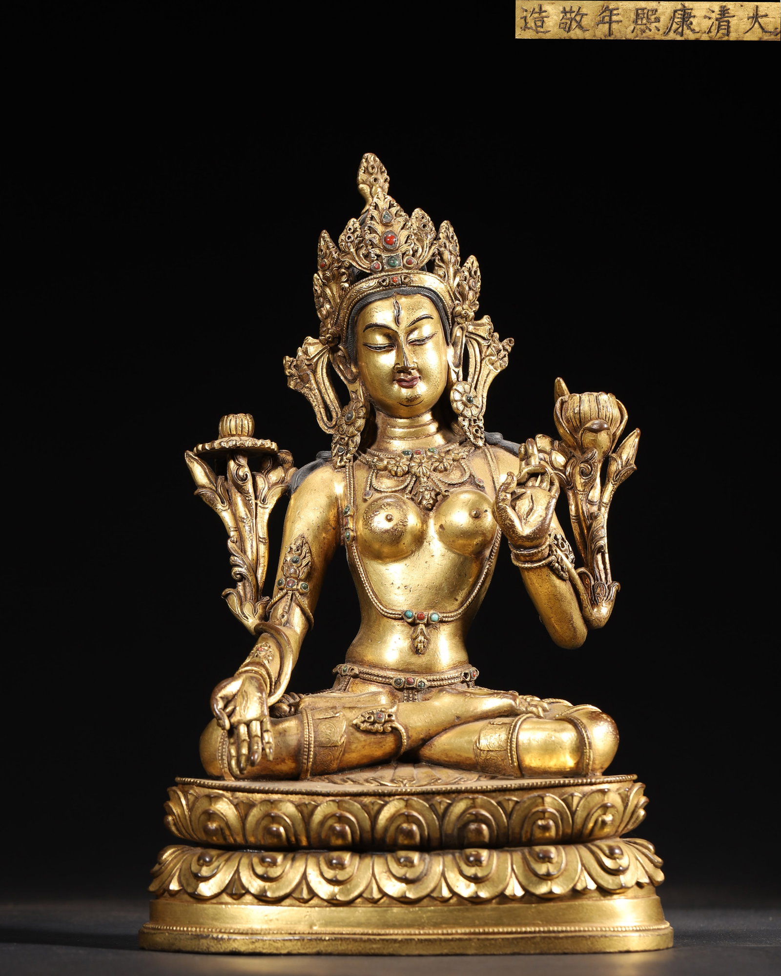 IMPERIAL COMMISSIONED GILT-BRONZE FIGURE OF WHITE TARA, QING DYNASTY, KANGXI PERIOD: 6.69" x 4.33" x 10.24" inches (17.0 cm x 11.0 cm x 26.0 cm) (Main) | Weight: 6.39 lbs (2900.0 g)A fine imperial gilt-bronze figure of White Tara, Kangxi period, Qing Dynasty. Exquisitely cast with ric