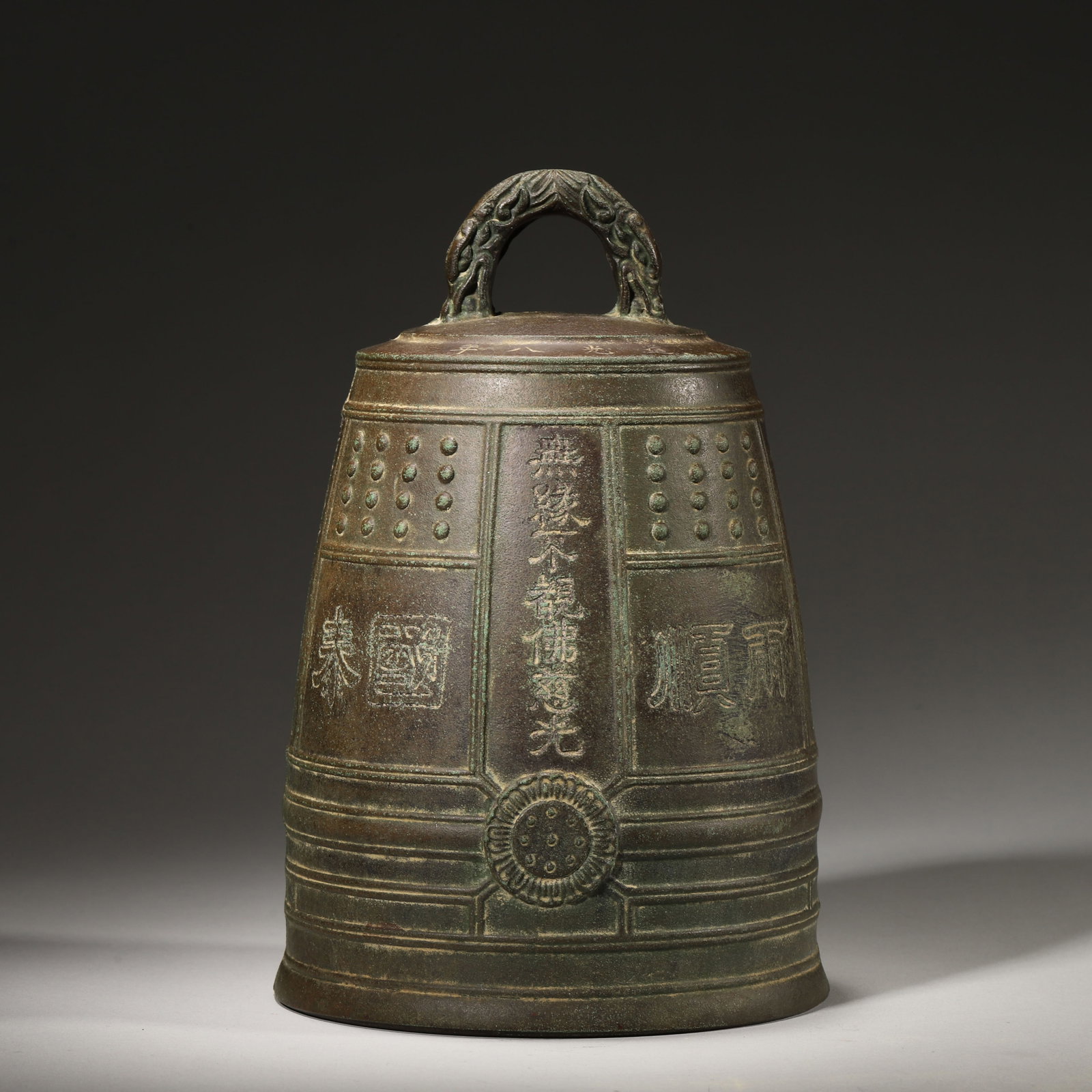 A Bronze Buddhist Temple Bell from Huayan Temple, Ming Dynasty: D 14.0cm (5.51 in); H 22.0cm (8.66 in); Wt 1984.0g (4.37 lb)This bronze temple bell features a dragon handle, inscriptions of Huayan Temple, Buddhist texts and auspicious phrases. With fine craftsmans
