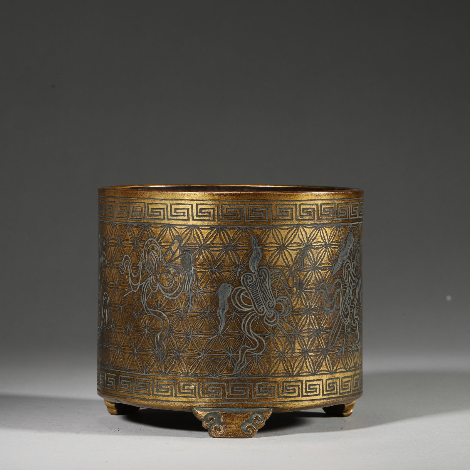 A Gilt-Bronze Censer with Silver-Inlaid "Eight Immortals" Motifs, Qing Dynasty: D 11.5cm (4.53 in); H 10.0cm (3.94 in); Wt 769.0g (1.7 lb)This tripod censer is made of gilt bronze with silver inlay, featuring the Eight Immortals motifs on a brocade ground. Marked "Yunjian Hu Wenm