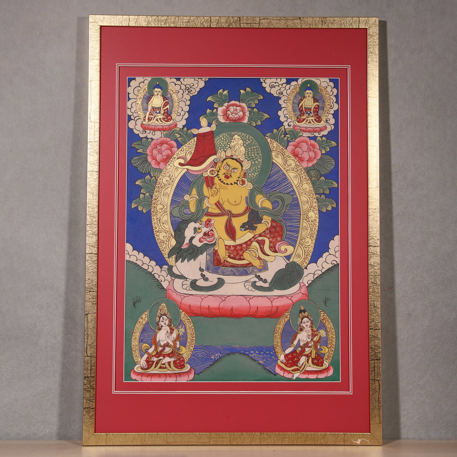A Thangka of Vaishravana, Qing Dynasty: L 68.0cm (26.77 in); W 48.0cm (18.9 in)This mineral pigment thangka depicts Vaishravana seated on a lion, surrounded by Buddhas and Bodhisattvas. With vivid colors and fine lines, it is a fine example