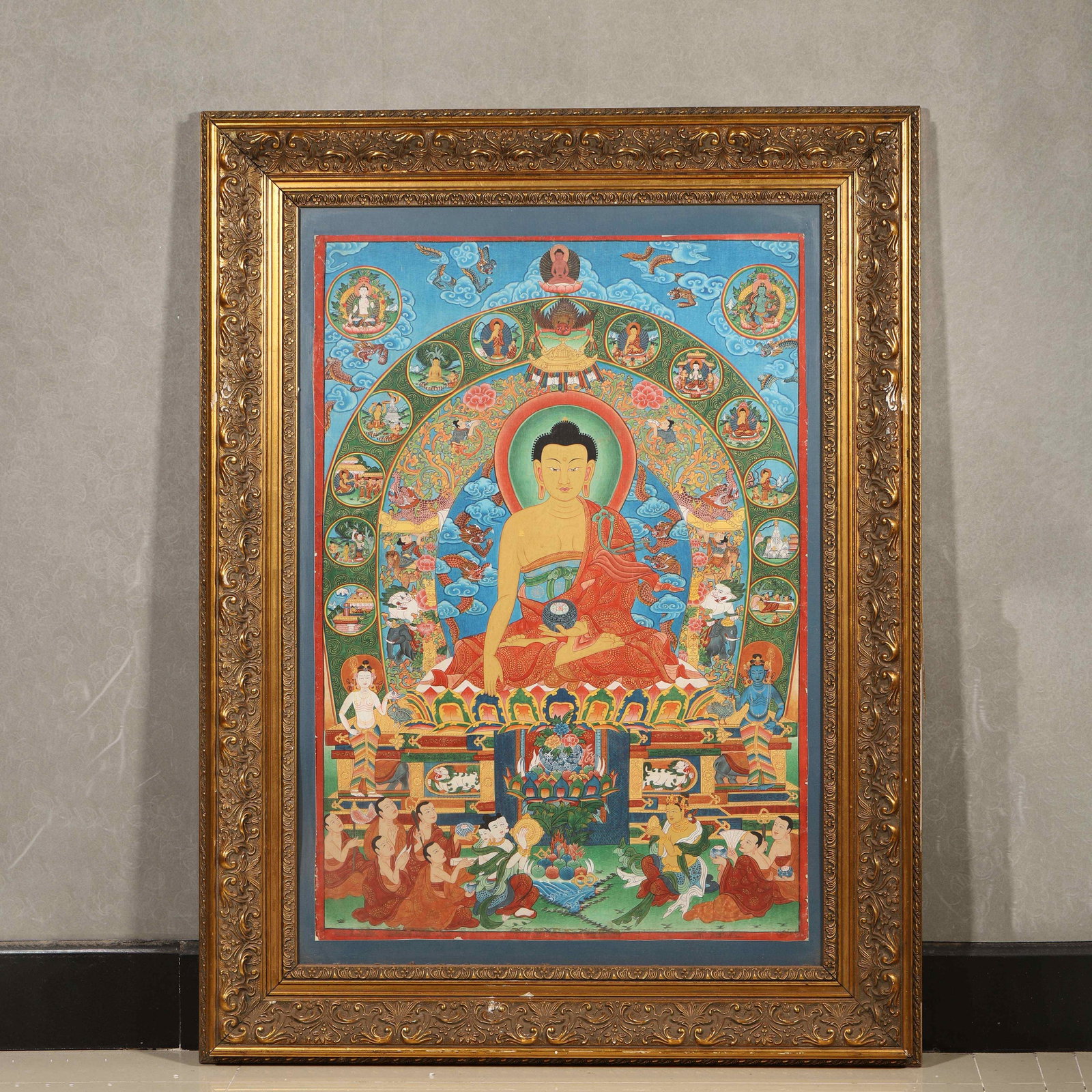 A Thangka of Shakyamuni Buddha, Qing Dynasty: L 104.0cm (40.94 in); W 79.0cm (31.1 in)This mineral-pigment thangka depicts Shakyamuni Buddha seated on a lotus throne, surrounded by Buddhas, Bodhisattvas and life scenes. With vivid colors and fine