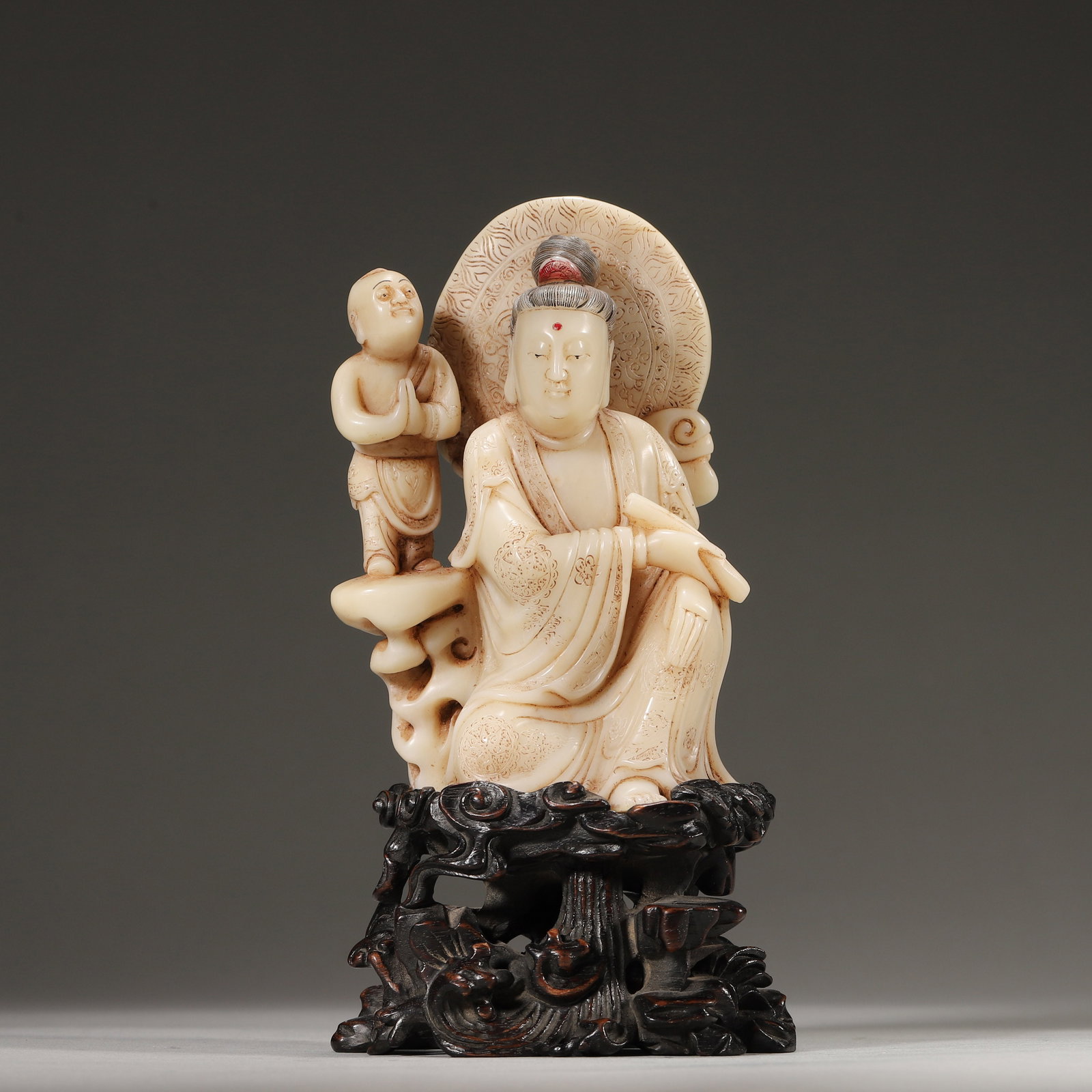 A Shoushan Stone Guanyin with Attendant Statue, Qing Dynasty: L 7.0cm (2.76 in); W 5.0cm (1.97 in); H 11.0cm (4.33 in); Wt 341.0g (0.75 lb)A Qing Dynasty statue of Guanyin with attendant, carved from fine Shoushan white Furong stone. The Guanyin sits in relaxed 