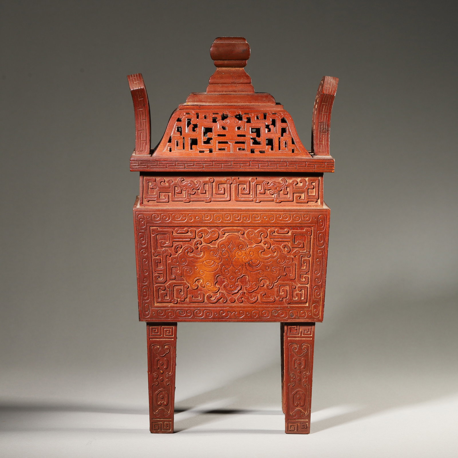 A Bamboo Carved Ding-Shaped Censer with Taotie Design, Qing Dynasty: L 15.0cm (5.91 in); W 12.0cm (4.72 in); H 28.0cm (11.02 in); Wt 651.0g (1.44 lb)A Qing Dynasty bamboo carved ding-shaped censer. The lid features openwork kui dragon patterns, while the body is carved