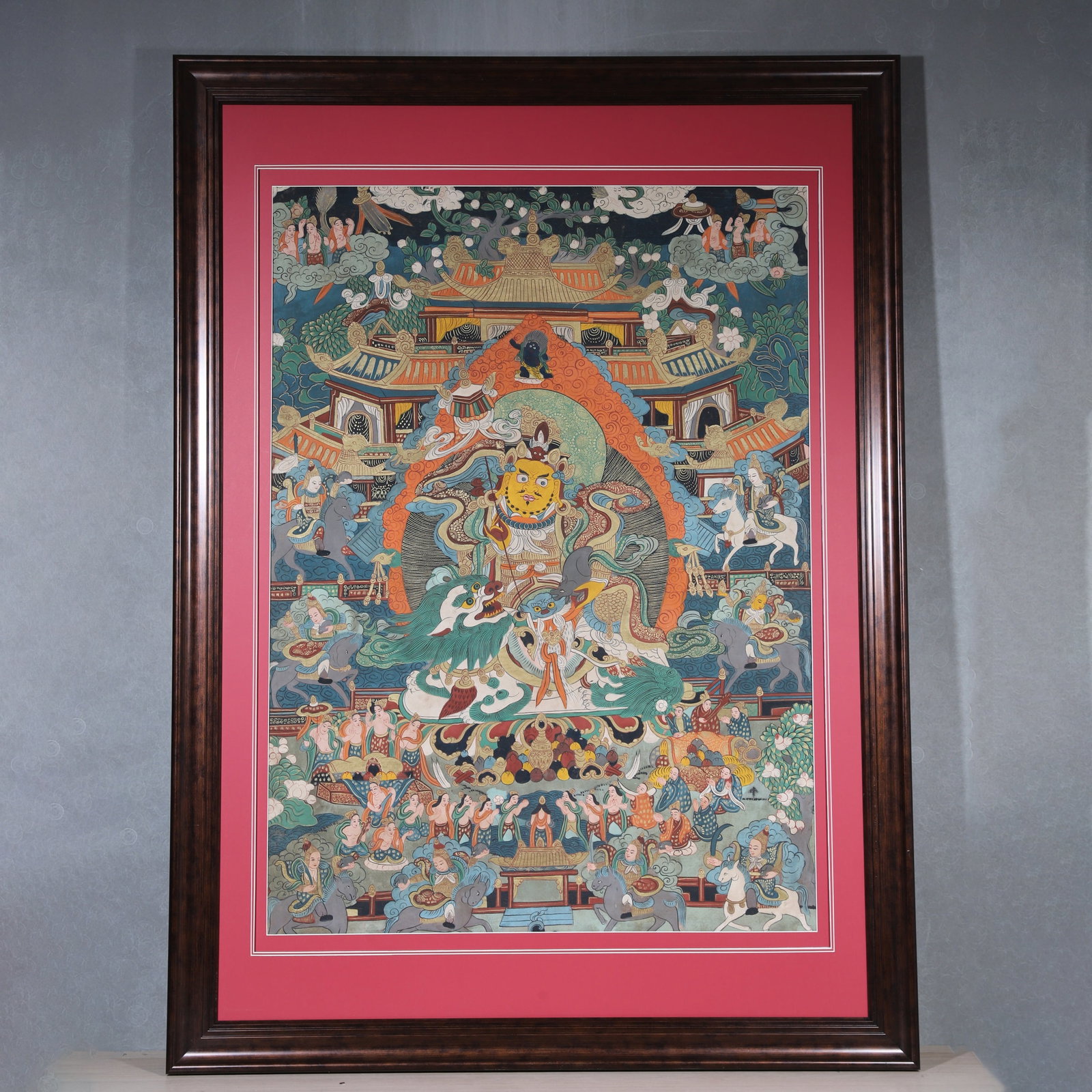 A Thangka of Yellow Jambhala, Qing Dynasty: Painting Core :L 107cm (42.13 in); W 78cm (30.71 in)A Qing Dynasty thangka of Yellow Jambhala, painted with mineral pigments and fine gold lines. The main deity rides a snow lion, holding a mongoose, 