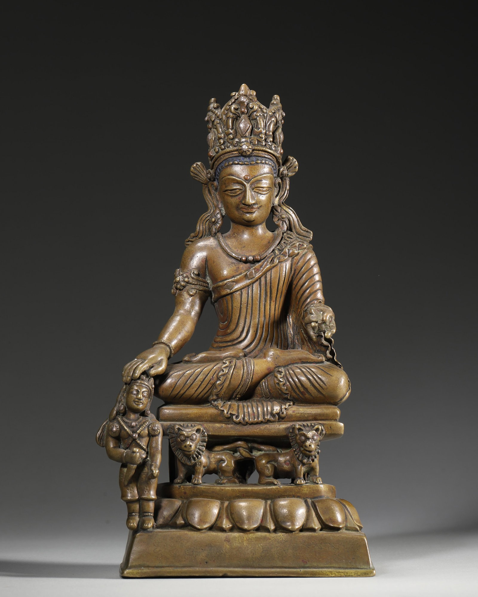 A BRONZE FIGURE OF A SEATED BODHISATTVA WITH ATTENDANT ON LION THRONE, 15TH–16TH CENTURY (1 of 9)