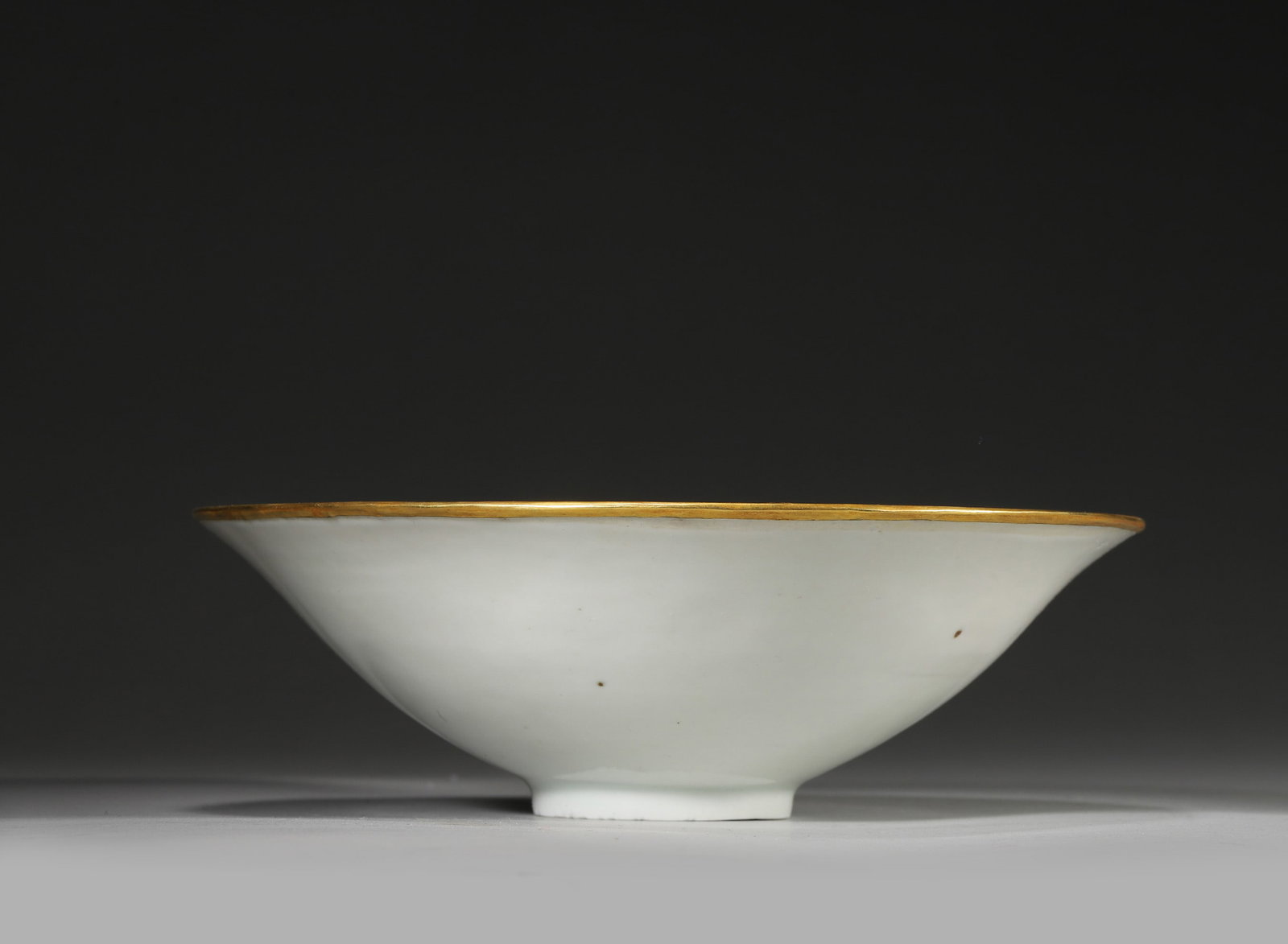 White Glazed Molded Bowl with Gilt Rim, Ding Kiln, Song Dynasty: Dimensions: diameter 8.8cm (3.46in) H: 6cm (2.36in). A fine Song Dynasty Ding kiln bowl with white glaze, molded with boy and goose patterns, featuring an exquisite gilt rim. Natural patina, exquisite