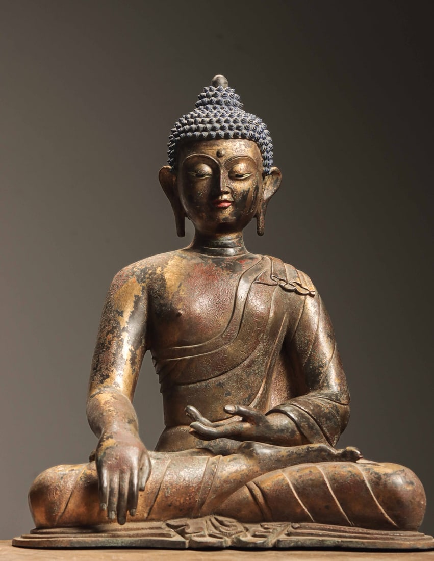 A GILT-BRONZE SEATED FIGURE OF SHAKYAMUNI BUDDHA, MING DYNASTY (1 of 10)