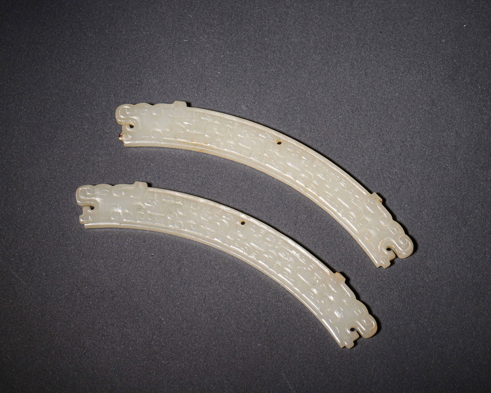 SPRING AND AUTUMN PERIOD, A PAIR OF WHITE JADE HUANG PENDANTS WITH DOUBLE DRAGON HEADS AND (1 of 6)