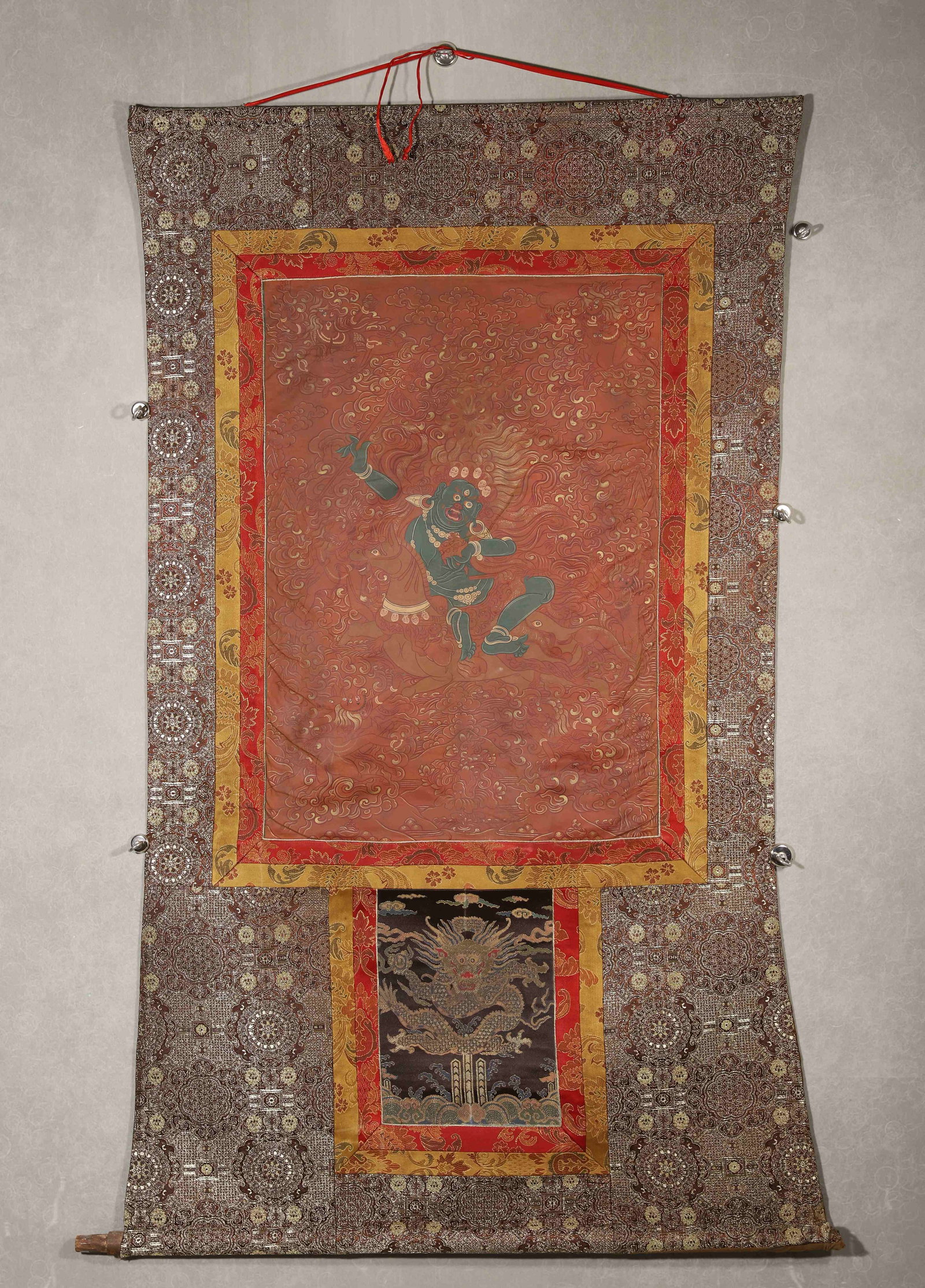 TIBETAN BUDDHIST APPLIQUÉ THANGKA OF PALDEN LHAMO WITH CINNABAR HANDPRINTS, 19TH CENTURY: 29.13in x 20.47in (74.0cm x 52.0cm)This 19th-century Tibetan appliqué Thangka depicts Palden Lhamo in vivid silk threads, with gilded cloud patterns. Cinnabar handprints on the reverse confirm sacred