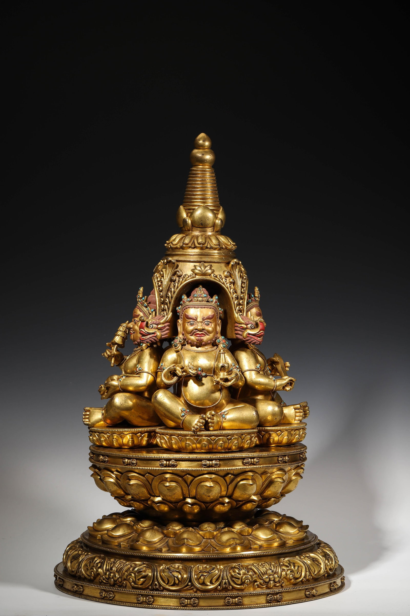 A RARE GILT-BRONZE INLAID GEM FOUR HEAVENLY KINGS STUPA STATUE, DENSATIL MONASTERY STYLE, 15TH: L: 38cm (14.96in) W: 38cm (14.96in) H: 61cm (24.02in) Weight: 27.3kg (60.19lb)A magnificent 15th-century Densatil Monastery style gilt-bronze stupa statue, inlaid with gems, featuring the Four Heavenl