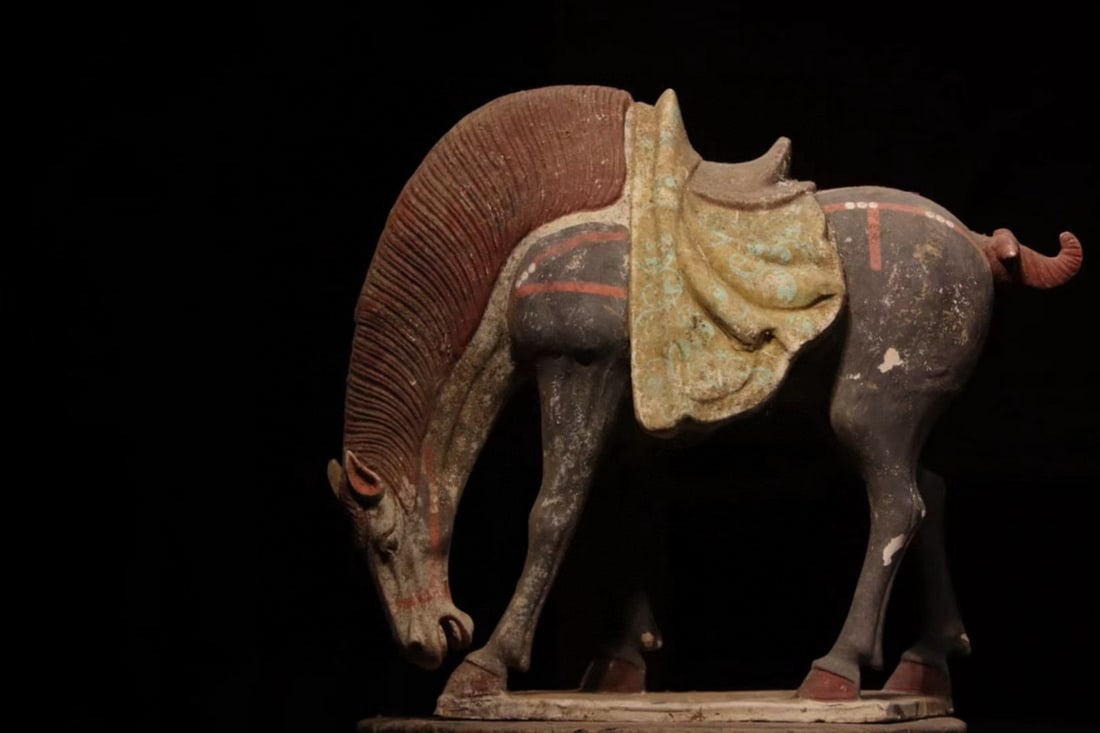 A POLYCHROME PAINTED POTTERY FIGURE OF A GRAZING HORSE, TANG DYNASTY, 7TH–9TH CENTURY (1 of 7)