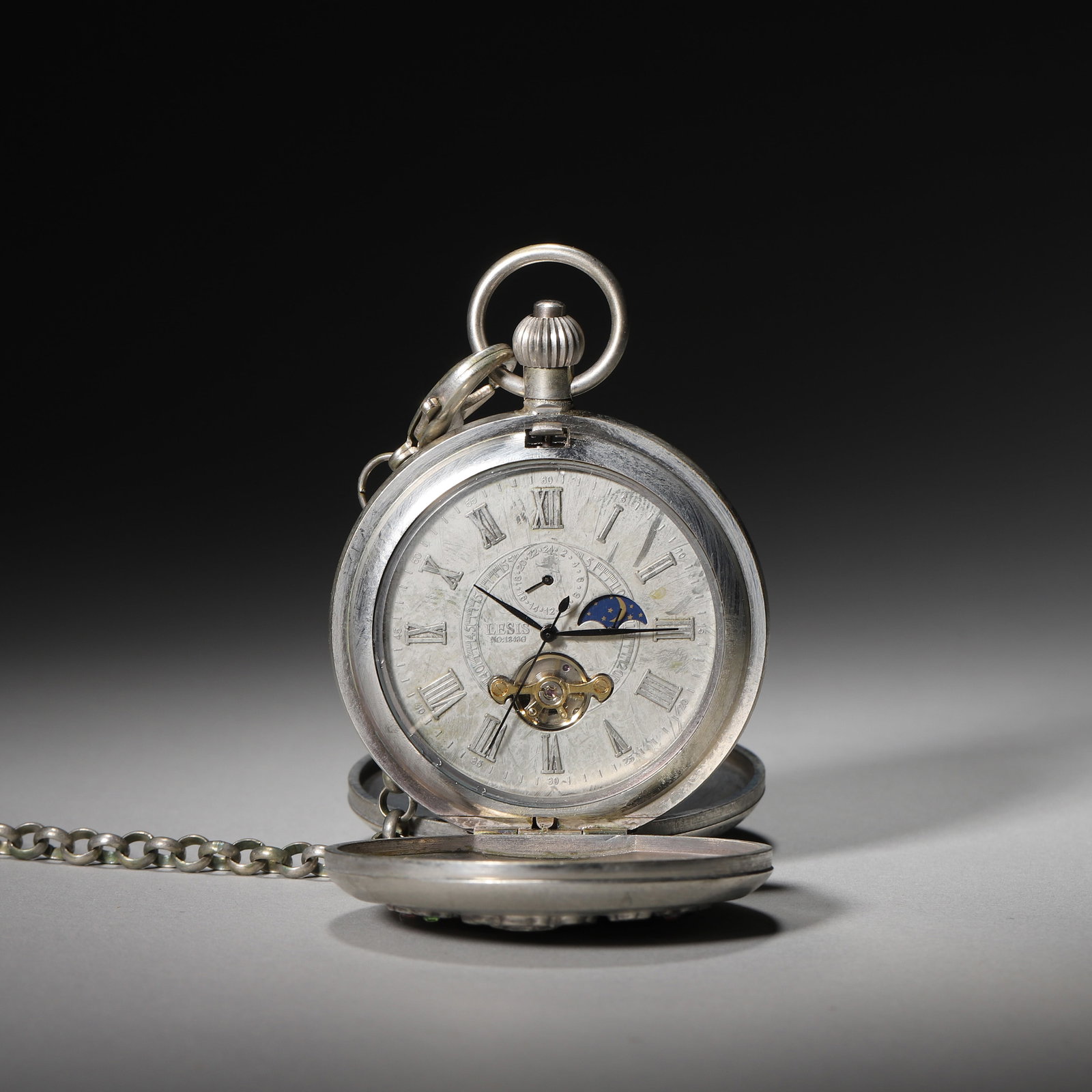 EARLY 20TH CENTURY SWISS SILVER 8-DAY OPEN HEART MOON PHASE POCKET WATCH(running normally): Diameter: 5.5cm (2.17in) Weight: 176g (0.39lb)A fine early 20th century Swiss silver 8-day pocket watch, open heart, moon phase, rose relief case with gem inlays, original chain, excellent craftsmansh
