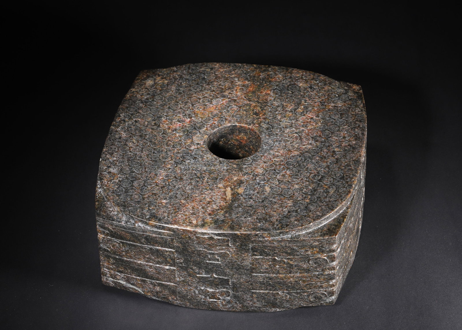 LIANGZHU CULTURE JADE CONG: 9.84in x 9.84in x 4.33in (25.0cm x 25.0cm x 11.0cm) 39.68lbs (18kg)A fine Liangzhu Culture jade cong, with square exterior and circular bore, carved with divine-human and beast-mask motifs. The dense 