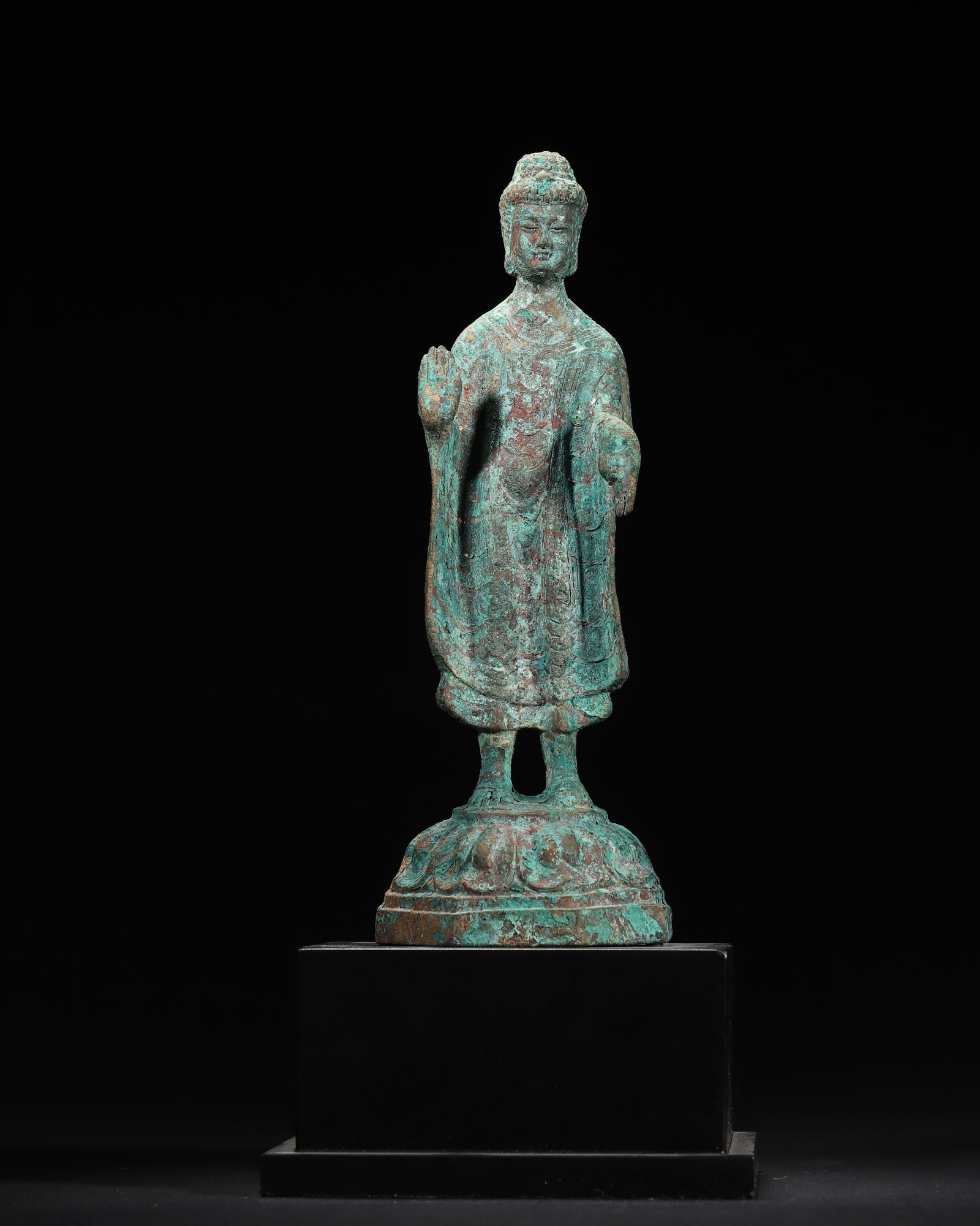 SUI TO EARLY TANG DYNASTY BRONZE STANDING SHAKYAMUNI BUDDHA STATUE: 2.76in x 2.76in x 8.27in (7.0cm x 7.0cm x 21.0cm), 1.662lb (754.0g)A fine Sui to Early Tang bronze standing Shakyamuni Buddha, with right hand in abhaya mudra, wearing a kasaya, standing on an octagon