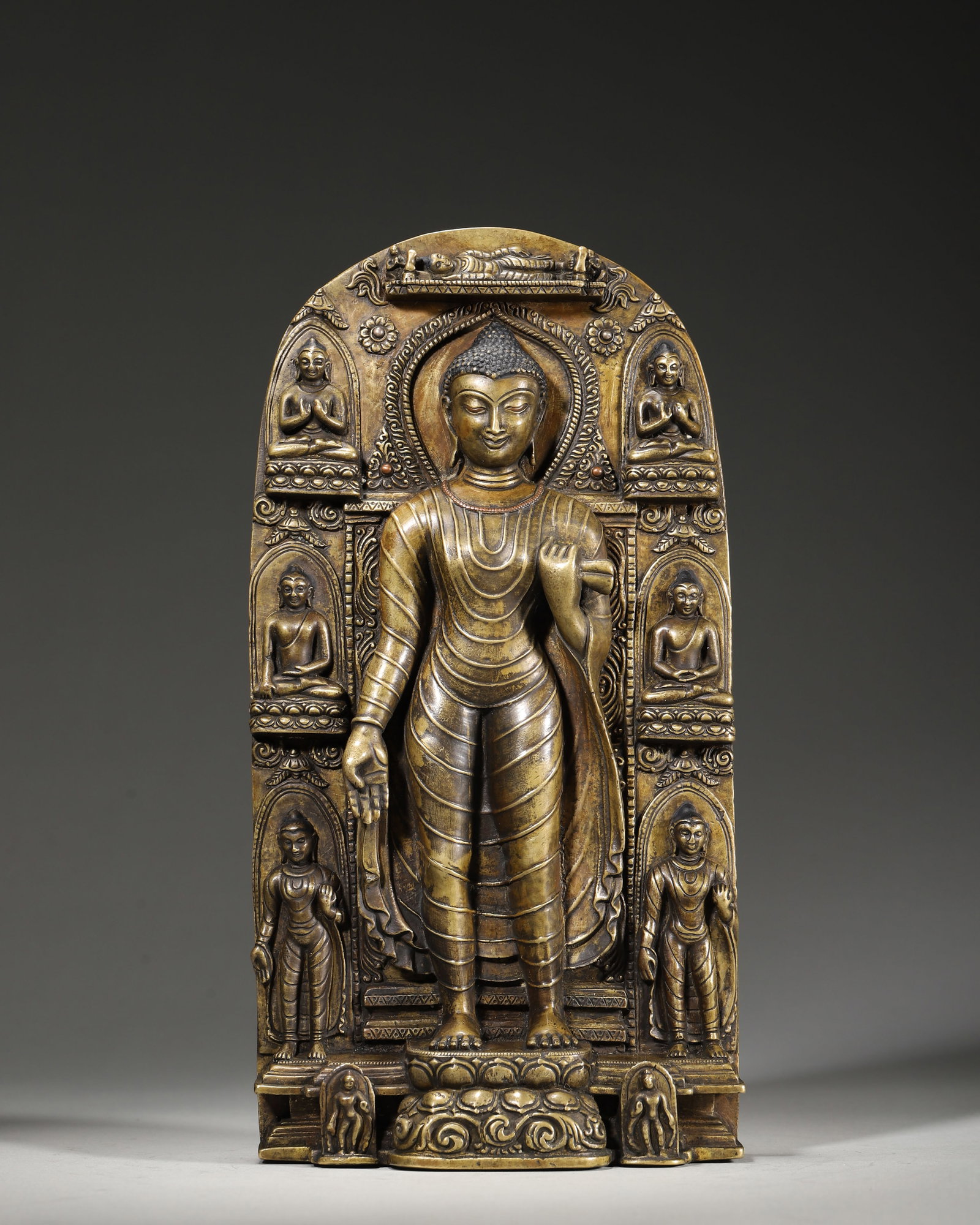 13TH–14TH CENTURY COPPER NICHE STATUE OF SHAKYAMUNI BUDDHA WITH EIGHT GREAT EVENTS: 4.72" x 1.97" x 1.97" x 9.84" (12cm x 5cm x 5cm x 25cm) 4.42lb (2006g)This 13th–14th century Tibetan Buddhist niche statue depicts Shakyamuni Buddha with Eight Great Events, cast in copper. It featu