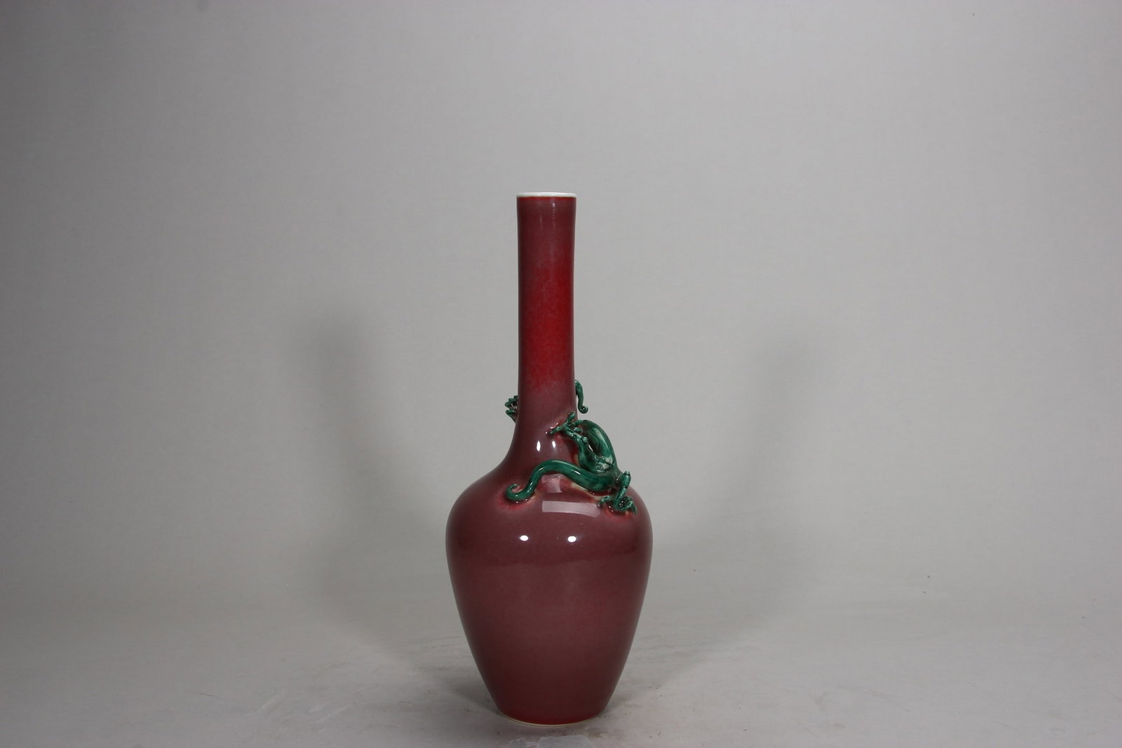 A FINE QING KANGXI PERIOD KIDNEY BEAN RED GLAZED VASE WITH APPLIED GREEN DRAGON: H10.83in (H27.5cm)This imperial vase features a delicate kidney bean red glaze with natural green speckles, paired with a vivid applied green dragon. A rare Kangxi masterpiece, showcasing exceptional 