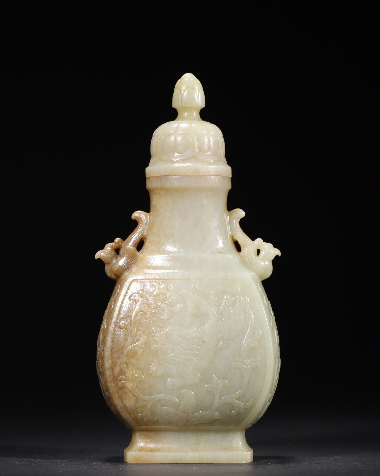 A FINE HETIAN PALE CELADON JADE VASE AND COVER WITH PHOENIX HANDLES AND AUSPICIOUS BEAST MOTIF,: 3.54in x 2.36in x 7.48in (9.0cm x 6.0cm x 19.0cm), 1.168lb (530.0g)This exquisite Qianlong-period Hetian pale celadon jade vase features natural sugar-colored inclusions, phoenix-shaped handles, and r
