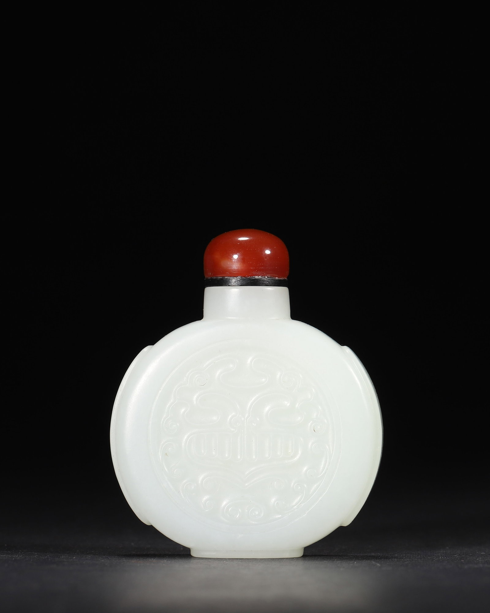 A FINE HETIAN WHITE JADE SNUFF BOTTLE WITH ARCHAISTIC BEAST MASK PATTERN, QIANLONG PERIOD, QING: 1.97in x 0.59in x 2.36in (5.0cm x 1.5cm x 6.0cm), 0.132lb (60.0g)This exquisite Qianlong-period Hetian white jade snuff bottle features a flattened round body and archaistic beast mask relief. Paired 