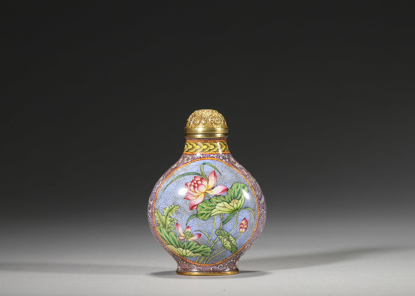 QIANLONG PERIOD, QING DYNASTY COPPER-BODIED ENAMEL SNUFF BOTTLE WITH FLORAL MEDALLIONS: 1.57in x 1.18in x 2.36in (4.0cm x 3.0cm x 6.0cm), 0.112lb (51.0g)A fine Qianlong period copper enamel snuff bottle with purple ground, floral medallions of lotus and peony, and gilt lid. Marked "Qianl