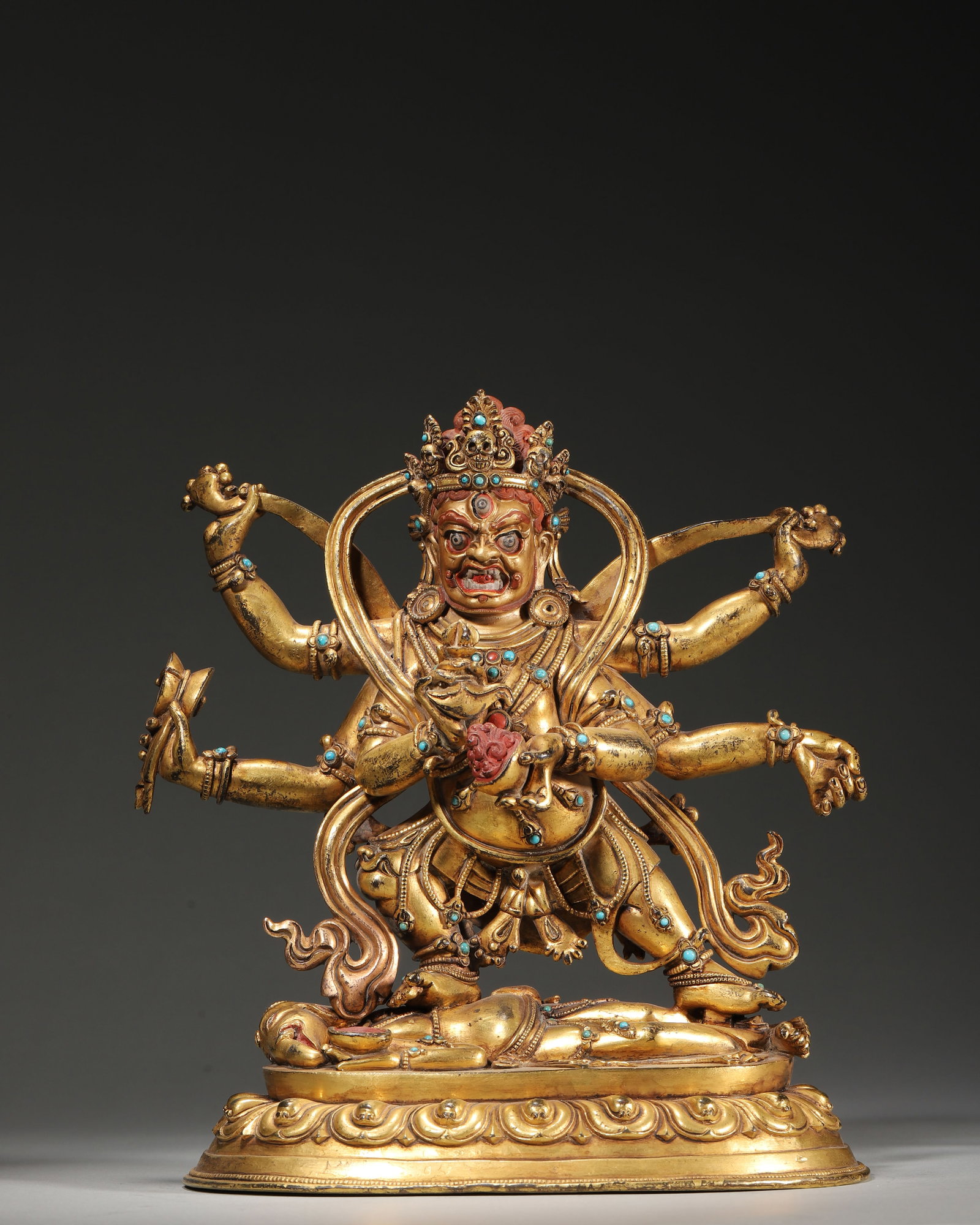 18TH–19TH CENTURY GILT-COPPER INLAID TURQUOISE STATUE OF SIX-ARMED MAHAKALA: 7.87" x 4.33" x 9.45" (20cm x 11cm x 24cm) 5.53lb (2507g)This 18th–19th century Tibetan Buddhist statue depicts Six-Armed Mahakala, cast in gilt copper with turquoise inlay. With a fierce six-armed 