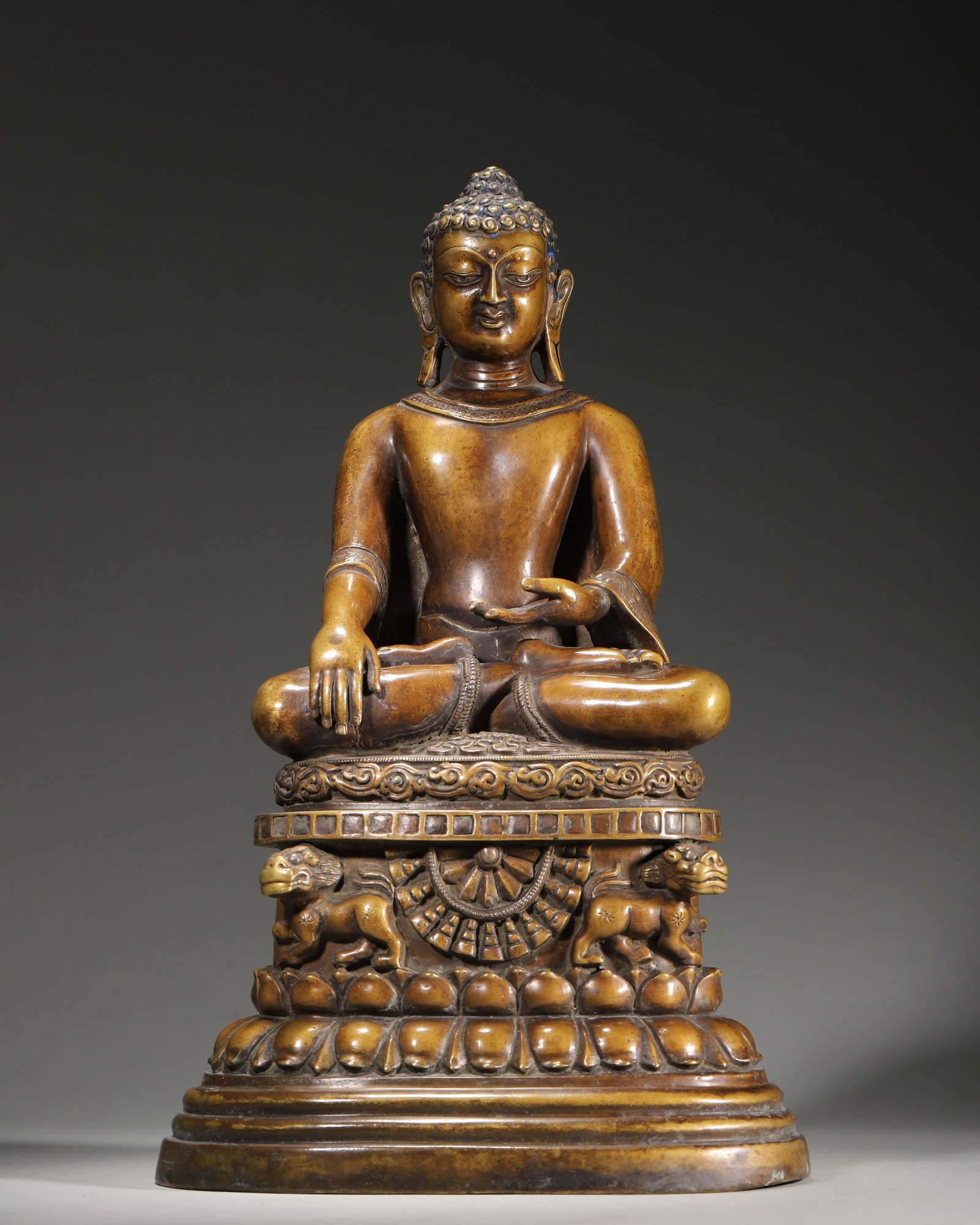 15TH–16TH CENTURY COPPER STATUE OF SHAKYAMUNI BUDDHA: 8.66" x 6.69" x 14.17" (22cm x 17cm x 36cm) 11.72lb (5316g)This 15th–16th century Tibetan Buddhist statue depicts Shakyamuni Buddha, cast in copper, with bhumisparsha and dhyana mudras. It features 