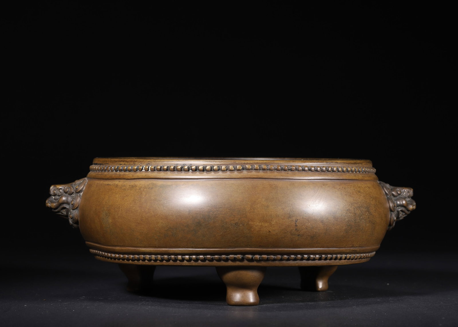 MING DYNASTY, CHONGZHEN PERIOD, A BRONZE TRIPOD CENSER WITH BEAST HANDLES, STUDDED DECORATION AND: 9.45" x 3.54" (24.0cm x 9.0cm) 7.088lb (3215g)This refined Chongzhen-period bronze censer features beast-head handles, studded bands, and sturdy tripod feet. With a rich aged patina and precise 'Shi S