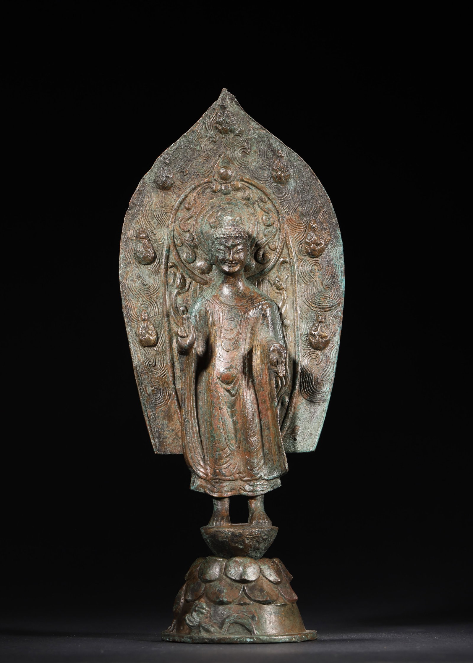 WESTERN WEI DYNASTY (5TH YEAR OF DATONG REIGN) BRONZE SHAKYAMUNI BUDDHA STATUE WITH MANDORLA: 4.72in x 3.15in x 11.02in (12.0cm x 8.0cm x 28.0cm), 2.112lb (958.0g)A fine Western Wei bronze Shakyamuni Buddha statue (dated 535 AD), with right hand in abhaya mudra, wearing a flowing robe, accompa