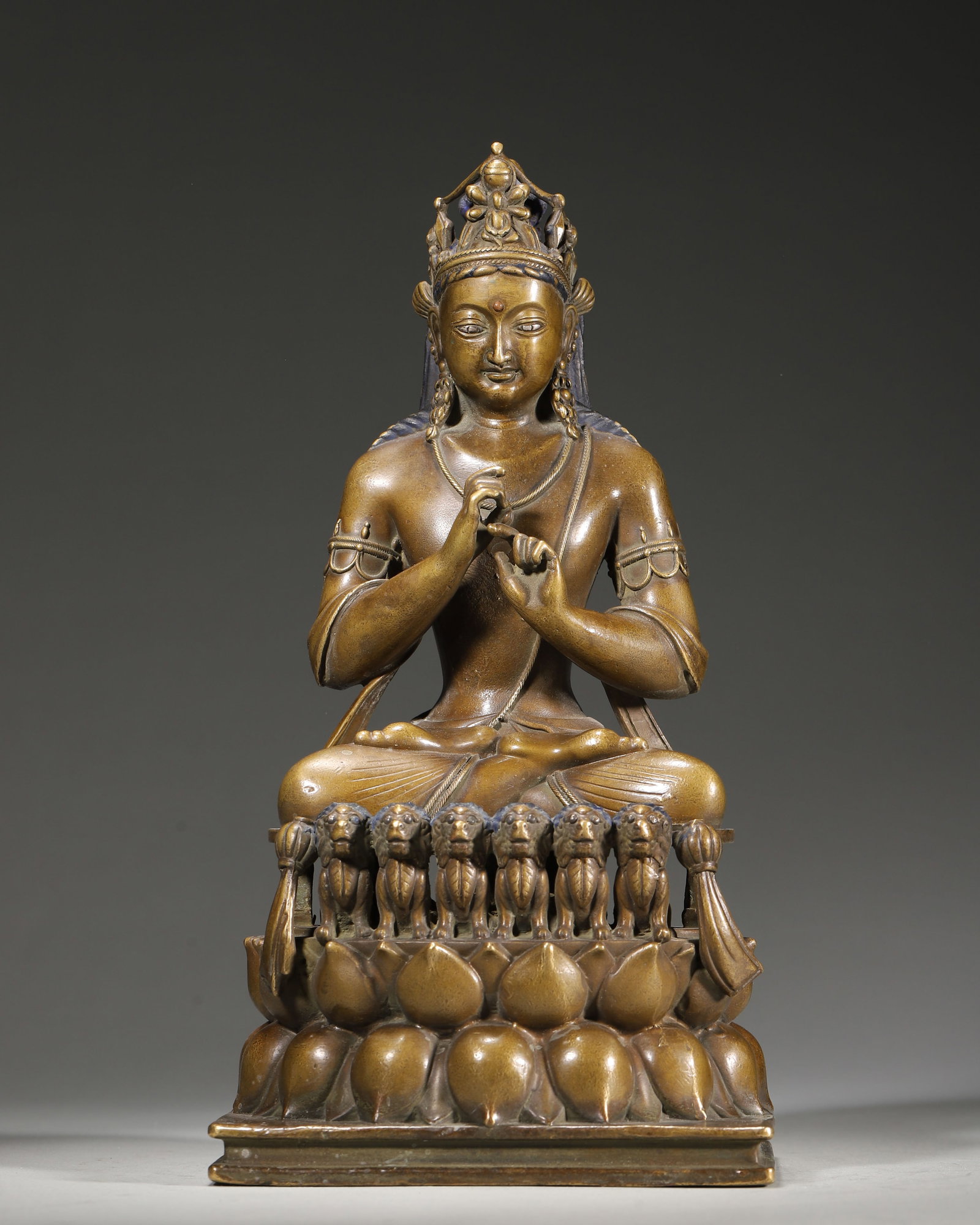 15TH–16TH CENTURY COPPER STATUE OF VAIROCANA: 5.12" x 4.33" x 9.84" (13cm x 11cm x 25cm) 3.67lb (1663g)This 15th–16th century Tibetan Buddhist statue depicts Vairocana, cast in copper, with wisdom fist mudra. It features a six-lion lotus throne