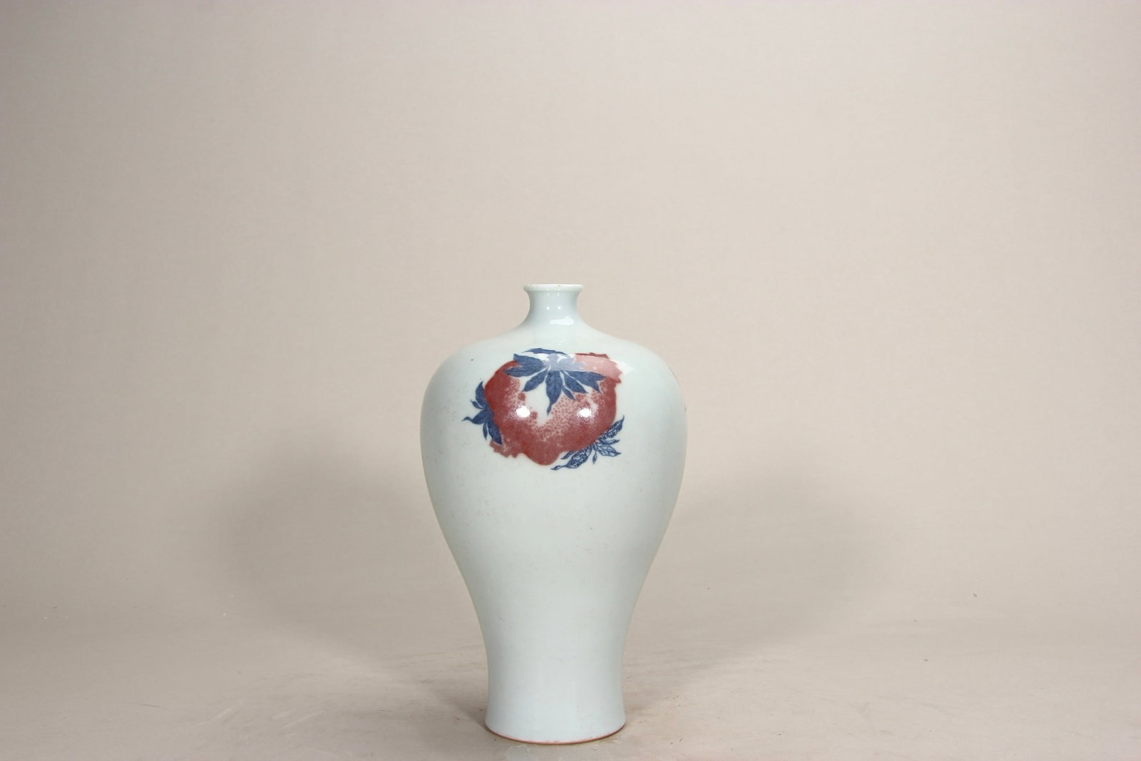 A FINE QING YONGZHENG BLUE AND WHITE AND COPPER-RED MEIPING VASE: H7.99in (H20.3cm)A fine Qing Yongzheng blue and white and copper-red meiping vase. Painted with 'Three Fruits' motifs of peaches, Buddha's hand and pomegranates, symbolizing fortune and longevity. A m