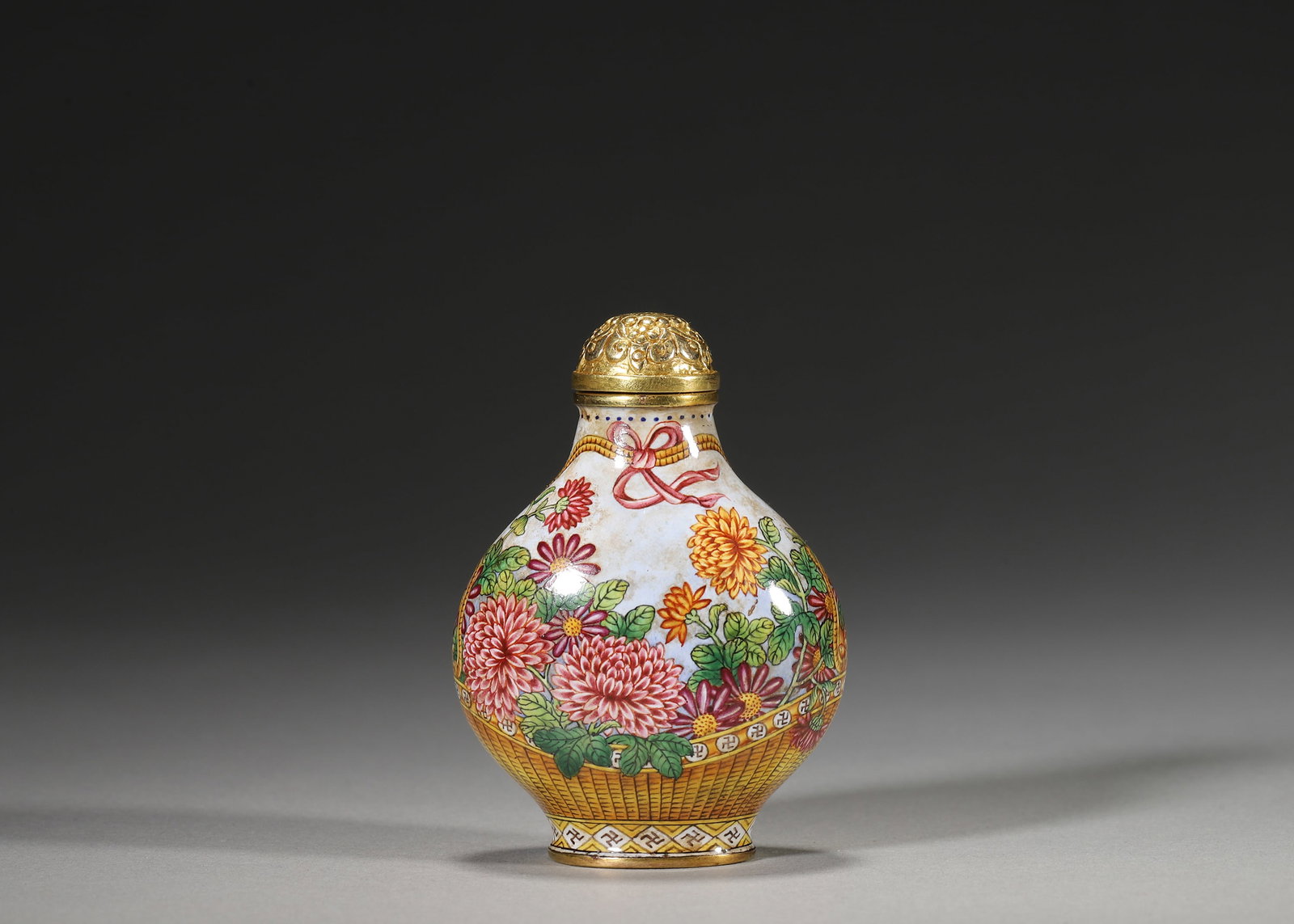 QIANLONG PERIOD, QING DYNASTY COPPER-BODIED ENAMEL SNUFF BOTTLE WITH BASKET AND THREE ABUNDANCES: 1.77in x 1.18in x 2.36in (4.5cm x 3.0cm x 6.0cm), 0.112lb (51.0g)A fine Qianlong period copper enamel snuff bottle with white ground, basket motifs of chrysanthemums and three abundances (peach, pomeg