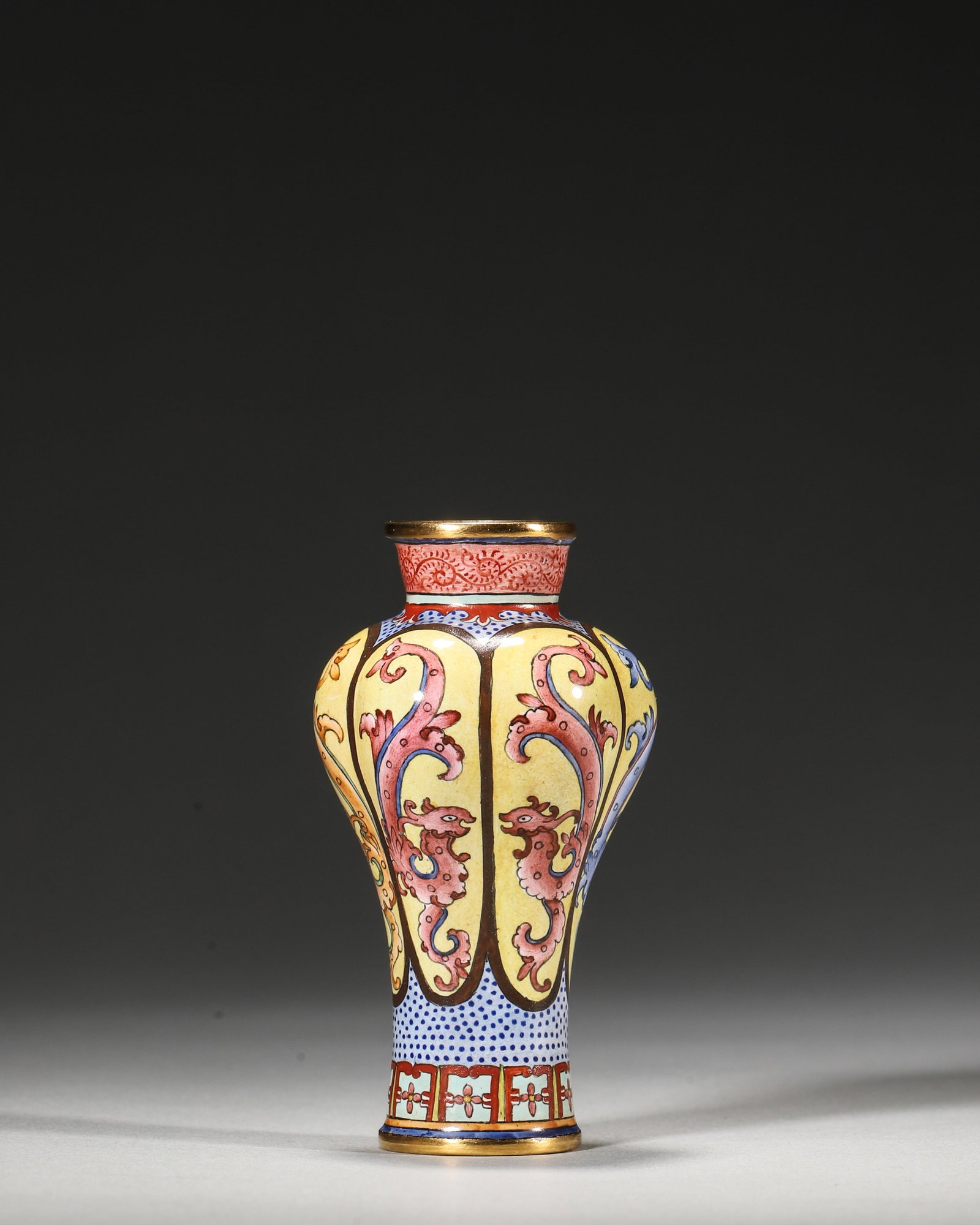 QIANLONG PERIOD, QING DYNASTY COPPER-BODIED ENAMEL VASE WITH KUI DRAGON MEDALLIONS: 1.57in (4.0cm), 0.132lb (60.0g)A fine Qianlong period copper enamel vase with yellow ground, lobed medallions of colorful kui dragons, and gilt rims. Marked "Qianlong Nian Zhi", it exemplifies imperia