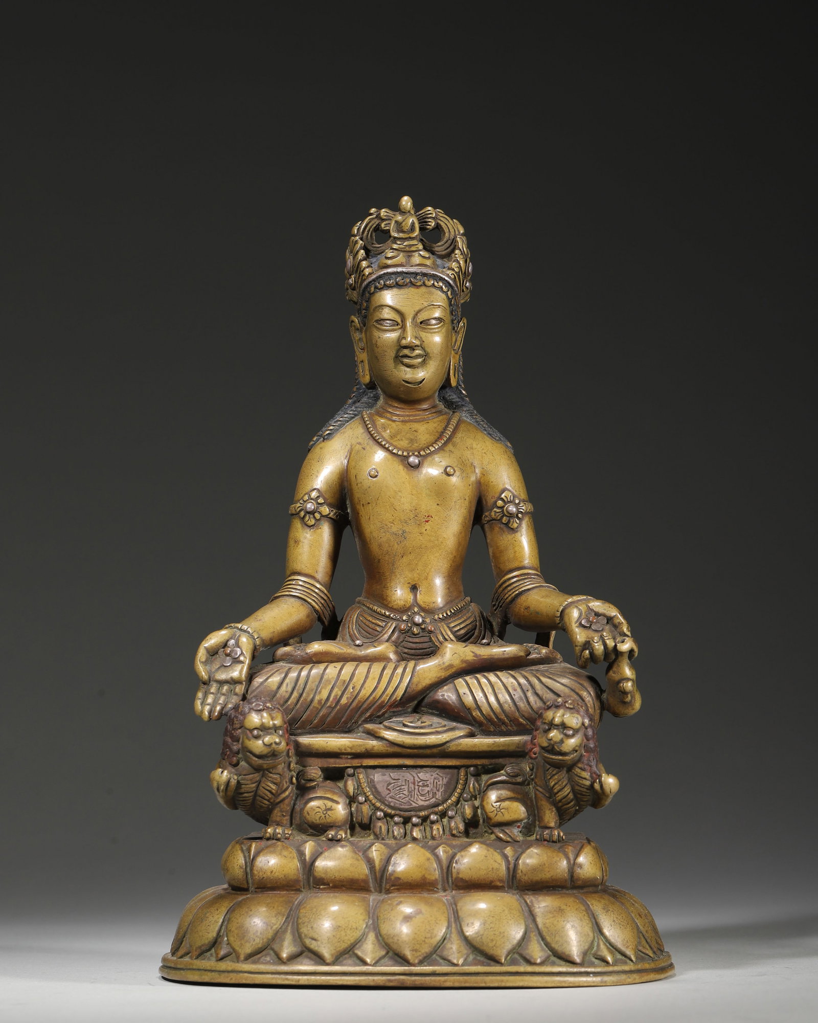 A COPPER ALLOY FIGURE OF JAMBHALA (YELLOW WEALTH DEITY) WITH SILVER INLAY AND INSCRIBED BASE,: 5.12in x 4.72in x 8.27in (13.0cm x 12.0cm x 21.0cm), 4.502lb (2042.0g)This 15th–16th century Himalayan copper Jambhala, seated on a double-lion throne, features silver inlay and inscribed base. With