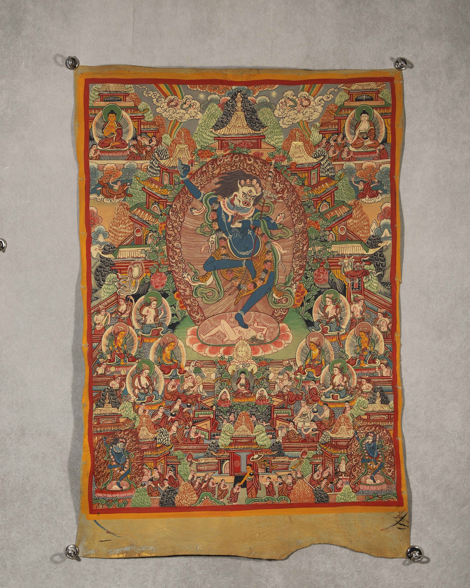 TIBETAN BUDDHIST DAKINI THANGKA WITH CINNAMU MANTRA, 19TH CENTURY: 31.50in x 22.83in (80.0cm x 58.0cm)This 19th-century Tibetan Thangka features a vividly depicted Dakini in dynamic pose, adorned with intricate gold details. Cinnamu mantras on the reverse signify sac