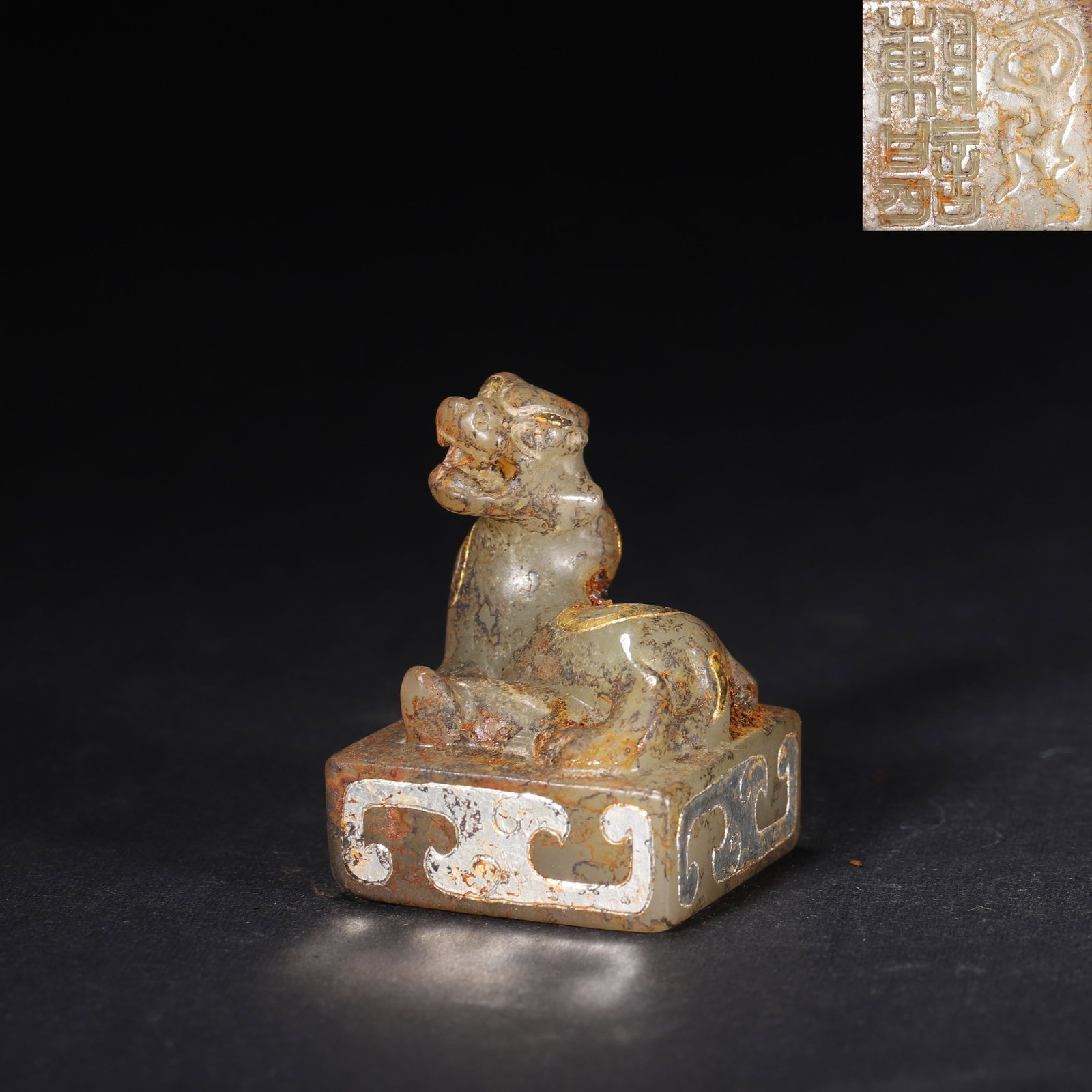 HAN DYNASTY GOLD & SILVER INLAID JADE SEAL WITH DIVINE BEAST KNOB: 1.1" x 1.1" x 1.46" (2.8cm x 2.8cm x 3.7cm) 0.086lb (39g)This exceptional Han Dynasty jade seal features a powerful divine beast knob and exquisite gold-silver inlay patterns. Its ancient patina and r