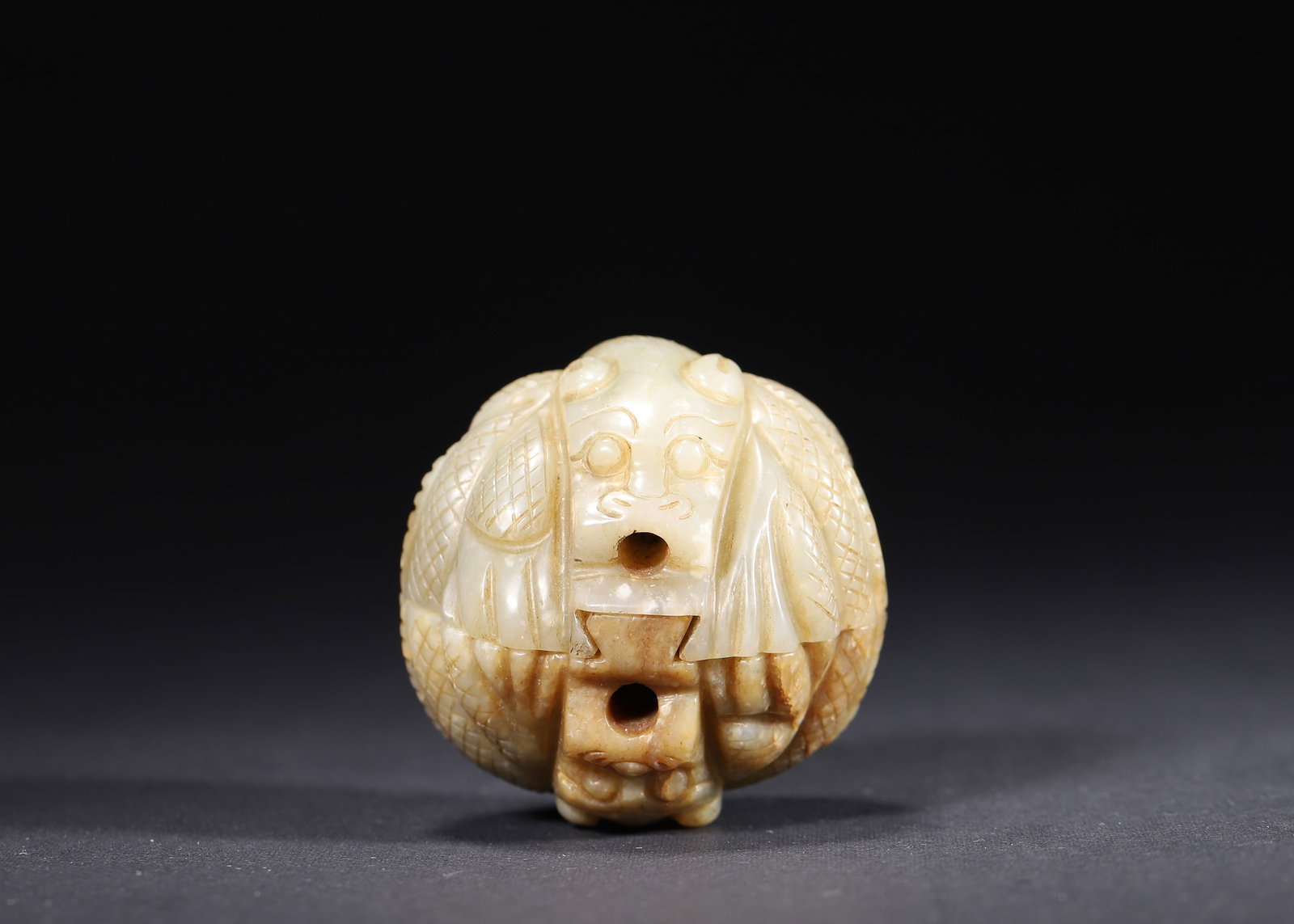 MING DYNASTY PAIR OF PALE GREEN JADE BEAST-FACE BELT BUCKLES: 1.89" (4.8cm) 0.313lb (142g)A fine pair of Ming Dynasty pale green jade belt buckles, carved with imposing beast-face motifs in high relief. Featuring natural russet inclusions and precise back slots 