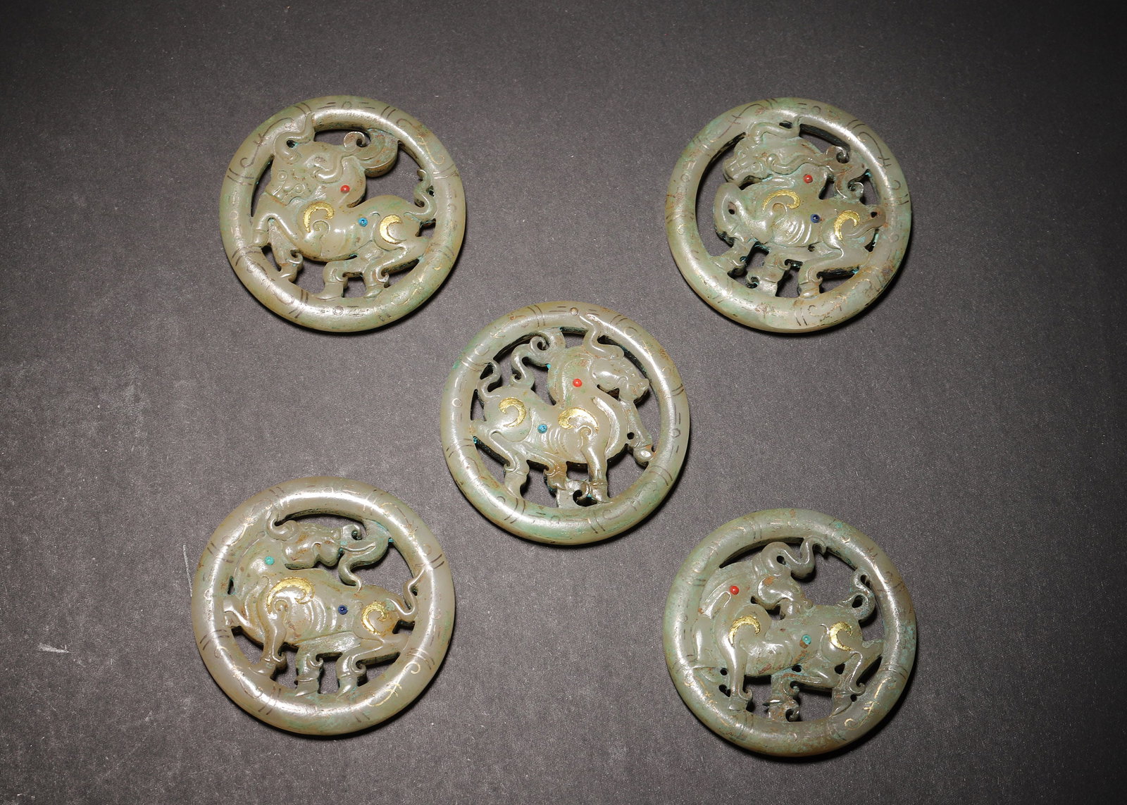 HAN DYNASTY HETIAN JADE OPENWORK RING PENDANTS WITH GOLD INLAY & GEM-SET BEAST MOTIFS (SET OF 5): 1.97in (5.0cm) 0.33lb (150.0g)An exceptional set of 5 Han Dynasty jade pendants, carved from fine Hetian jade. Each features openwork beast motifs, gold inlay, and inset gems. A masterpiece of Han jad