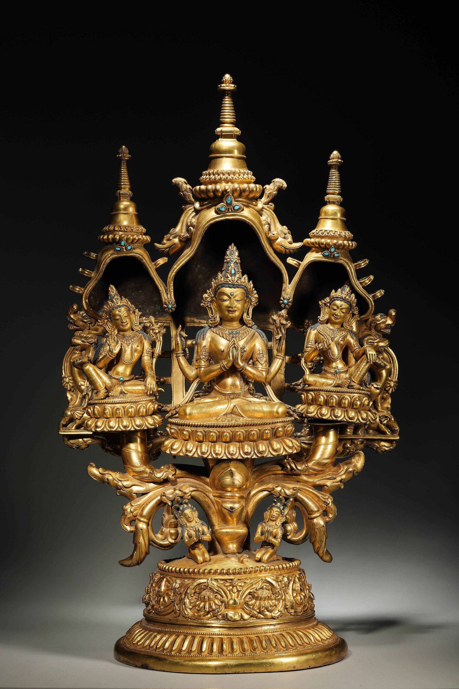 A GILT-BRONZE AND TURQUOISE-INLAID THREE PROTECTORS STATUE, QING DYNASTY: L: 38cm (14.96in) W: 23cm (9.06in) H: 65cm (25.59in) Weight: 18kg (39.68lb)This magnificent Qing Dynasty gilt-bronze and turquoise-inlaid Three Protectors statue features exquisite craftsmanship, rich