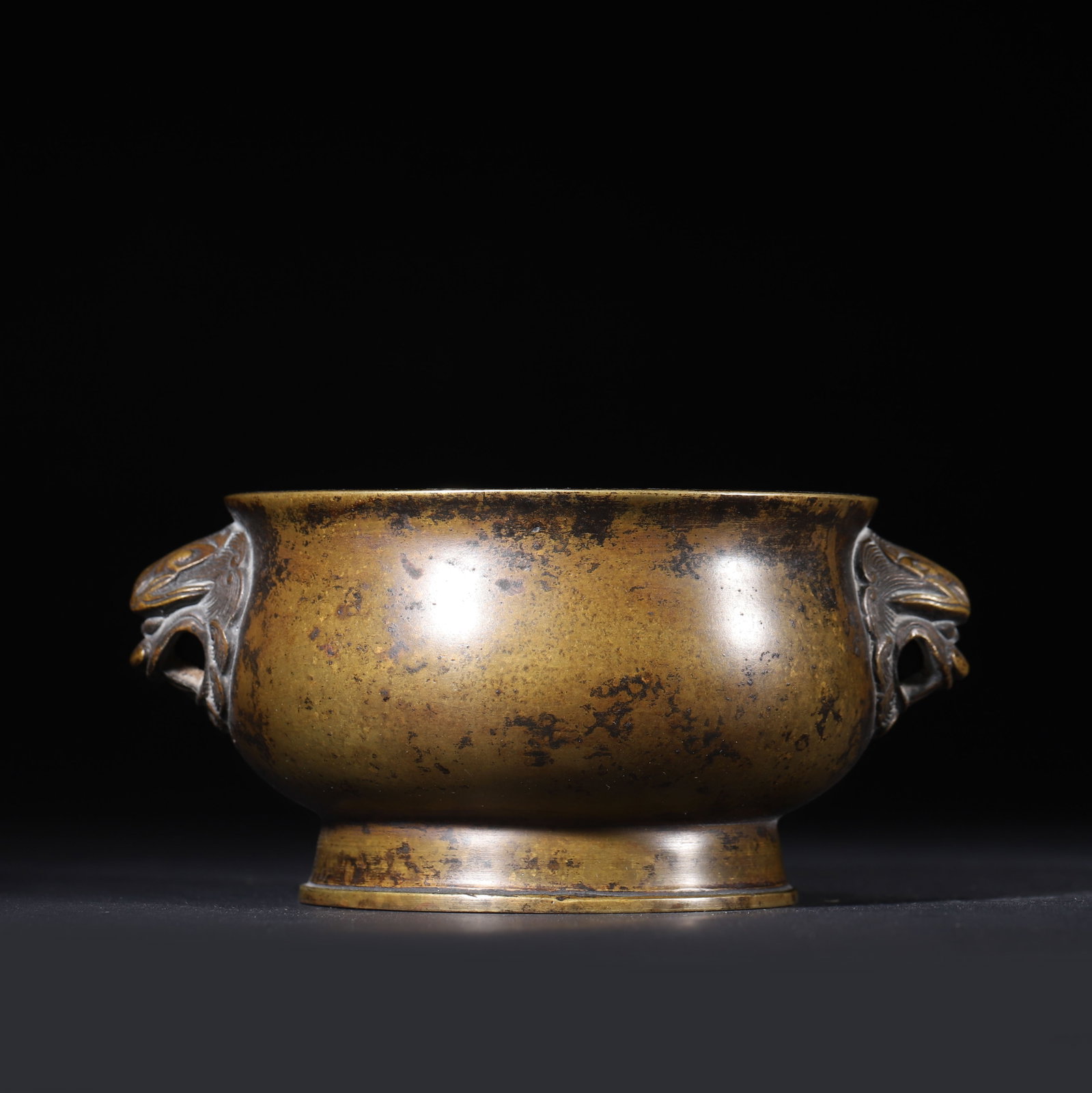 QING DYNASTY BRONZE CENSER WITH BEAST HANDLES, SHENG BAOJU MARK: 5.12" x 2.36" (13.0cm x 6.0cm) 1.272lb (577g)This refined Qing Dynasty bronze censer, bearing the "Sheng Baoju" mark, follows Ming Xuande prototypes. It features robust beast-head handles and a rich c